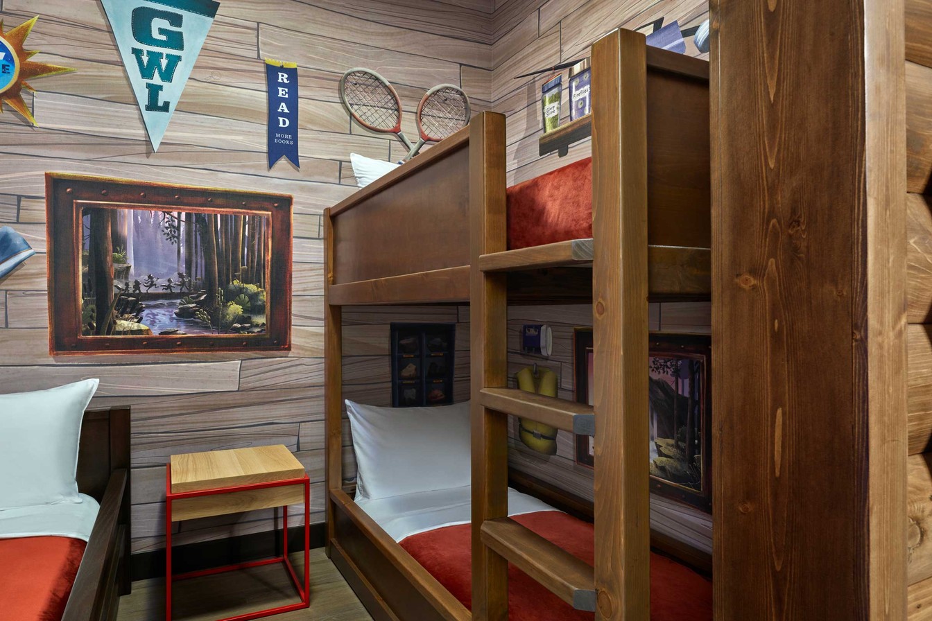 bunks beds and a day bed in a cabin themed suite
