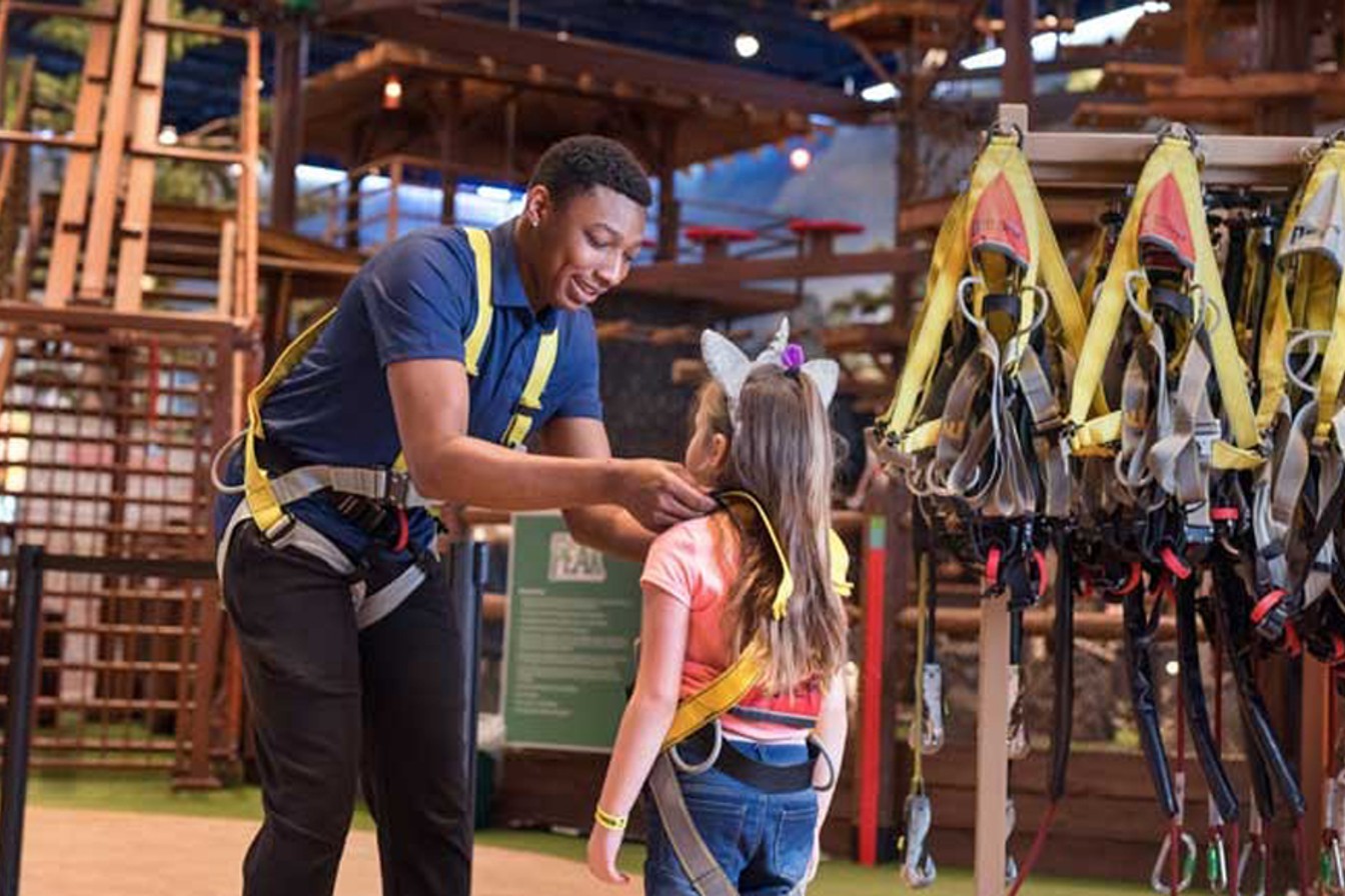 GW employee helps girl with her climbing harness