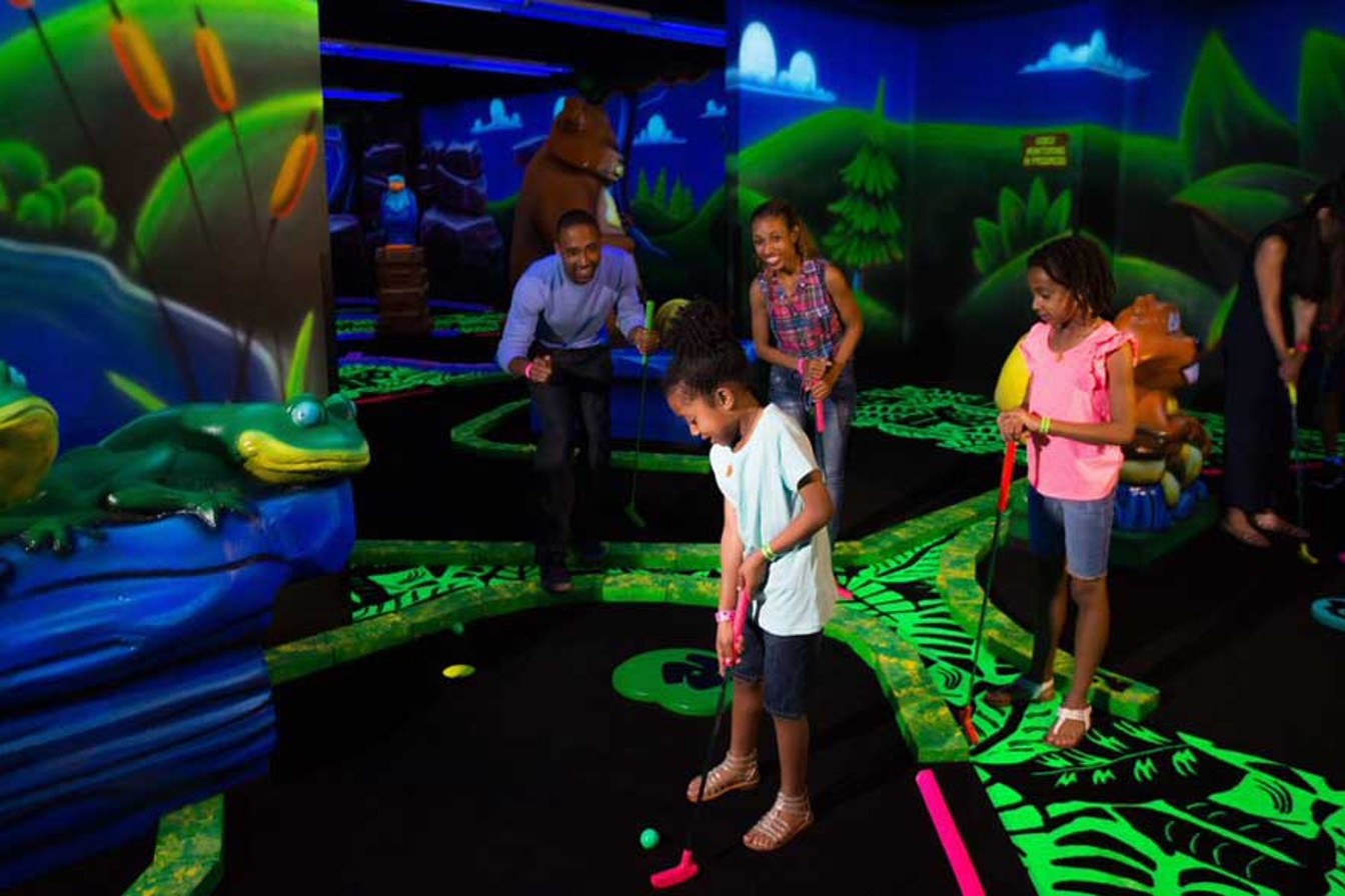 guests playing a game of mini golf
