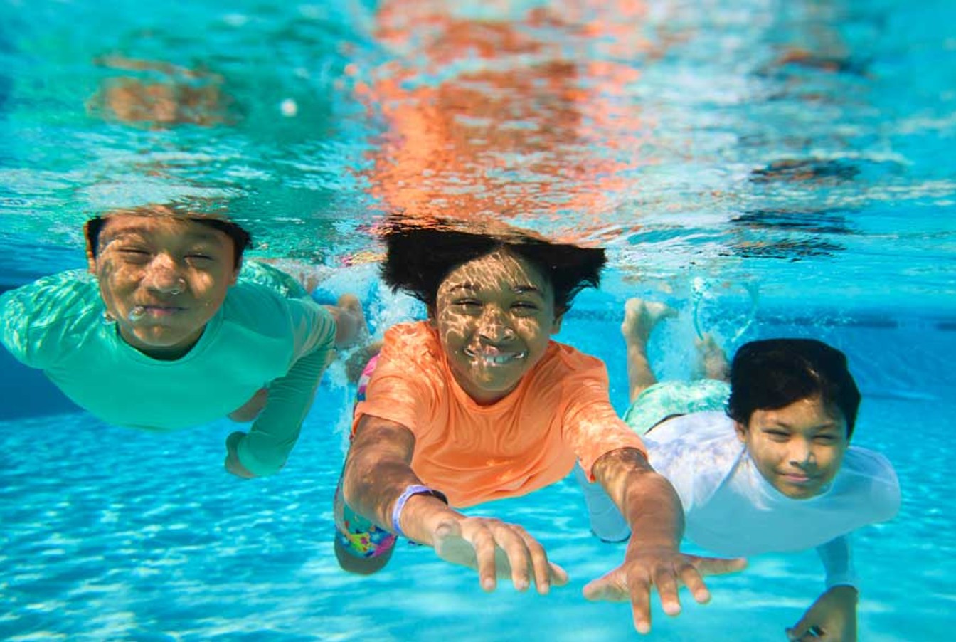 young kids enjoying a dip in the pool