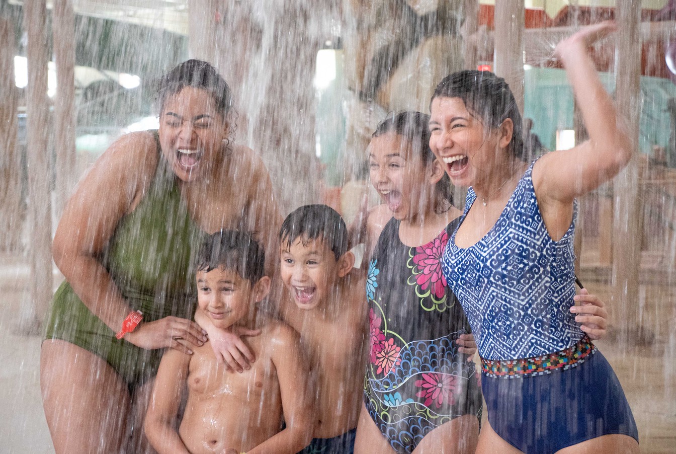 Family of five enjoying the indoor water park at Great Wolf 