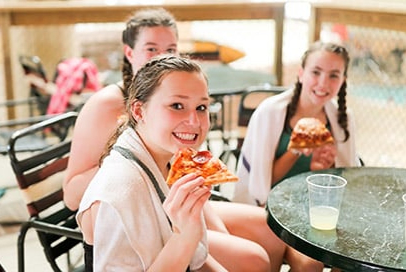Kids enjoy pizza and drinks in their own private seating at Great Wolf Lodge indoor water park and resort.