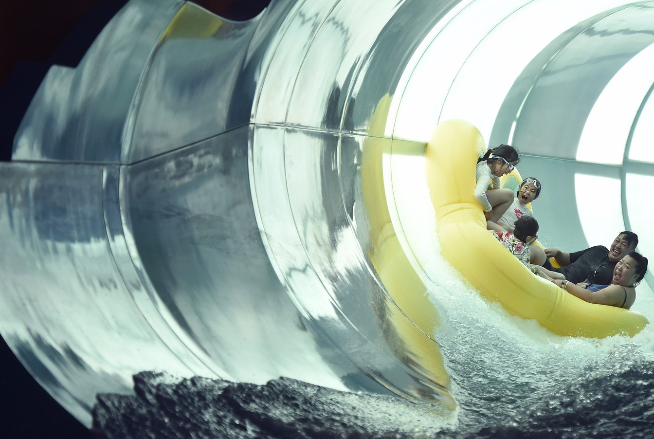 Family enjoying a water ride in a tube