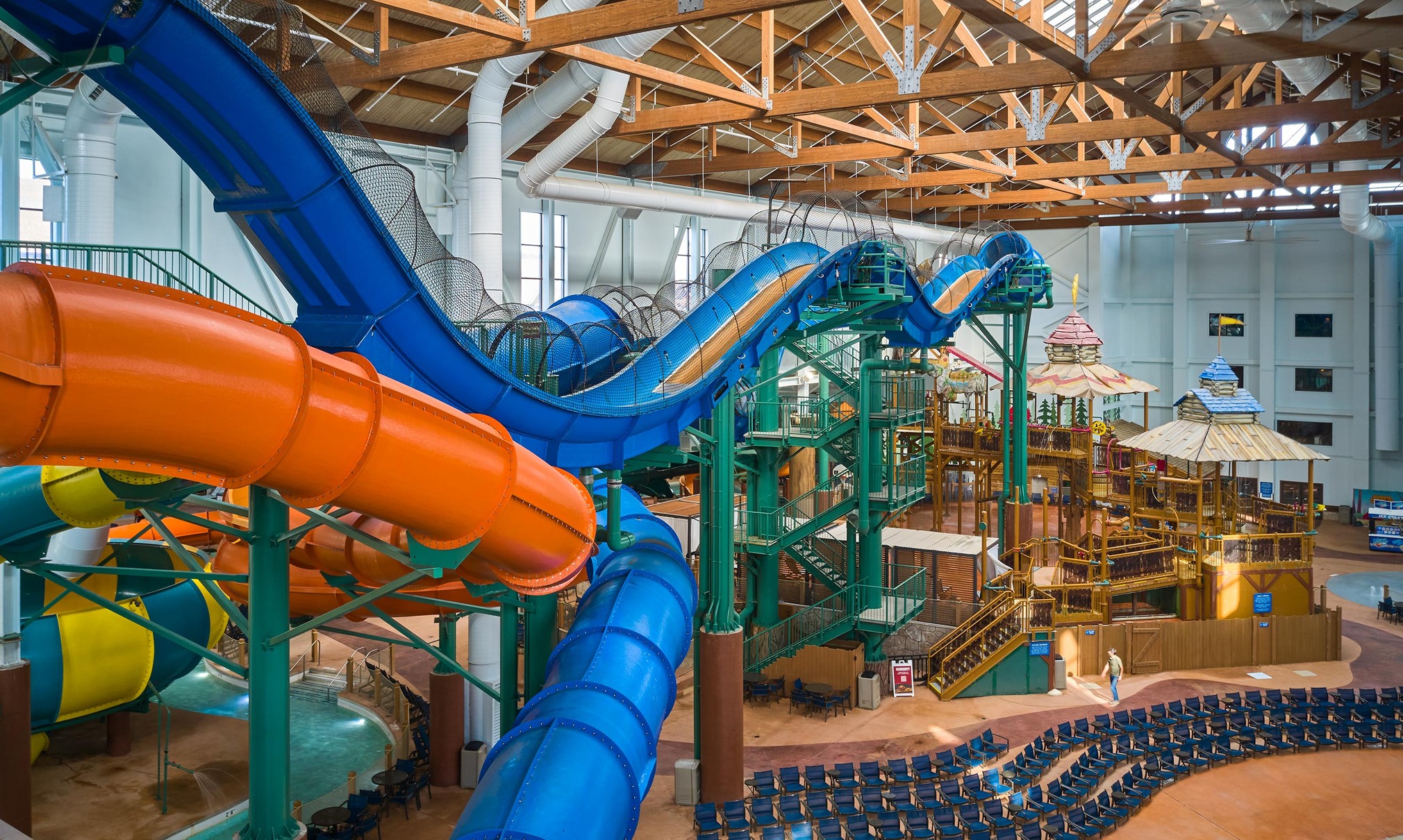 view of the indoor water park with a yellow and blue slide