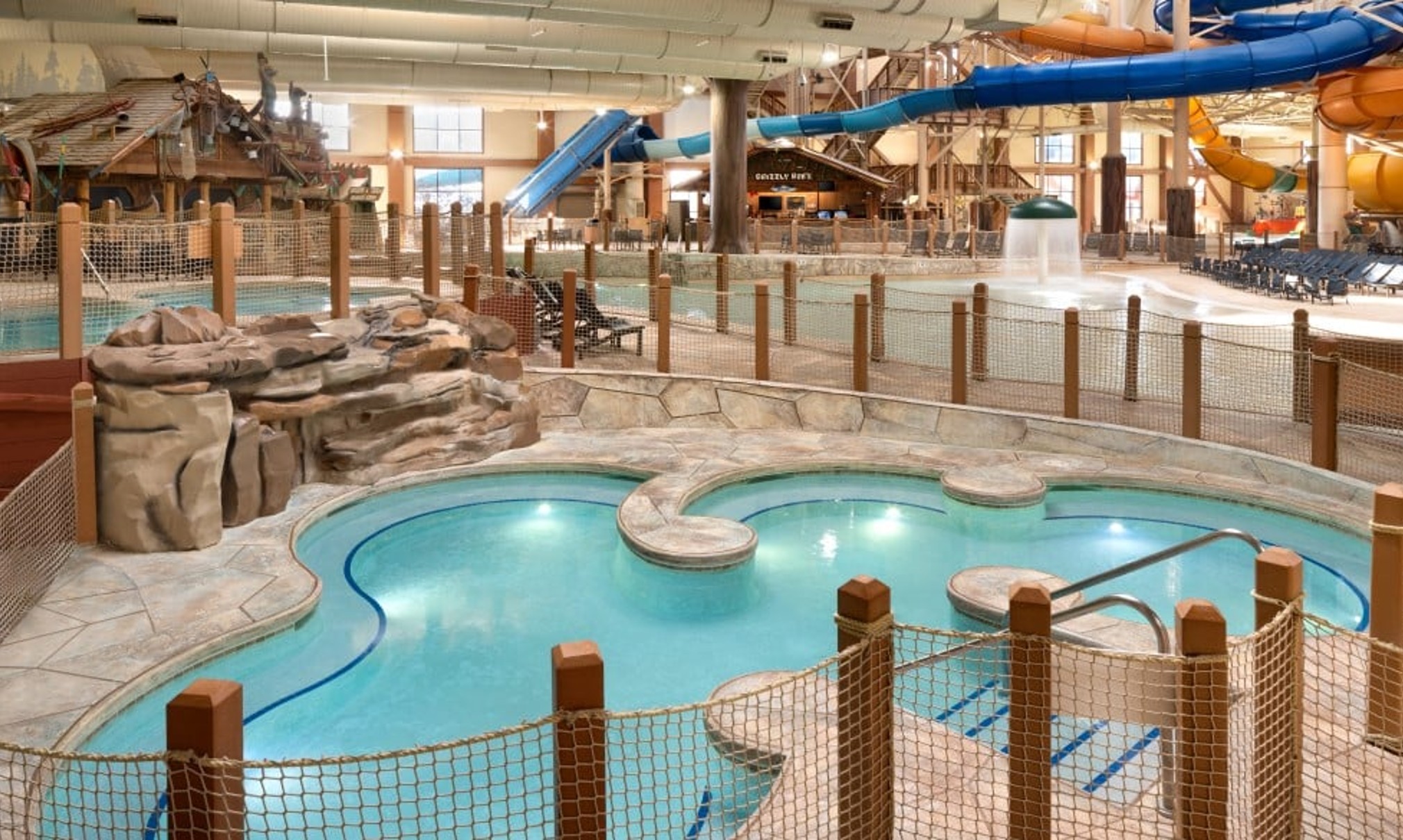 A family of four relaxes in the indoor pool