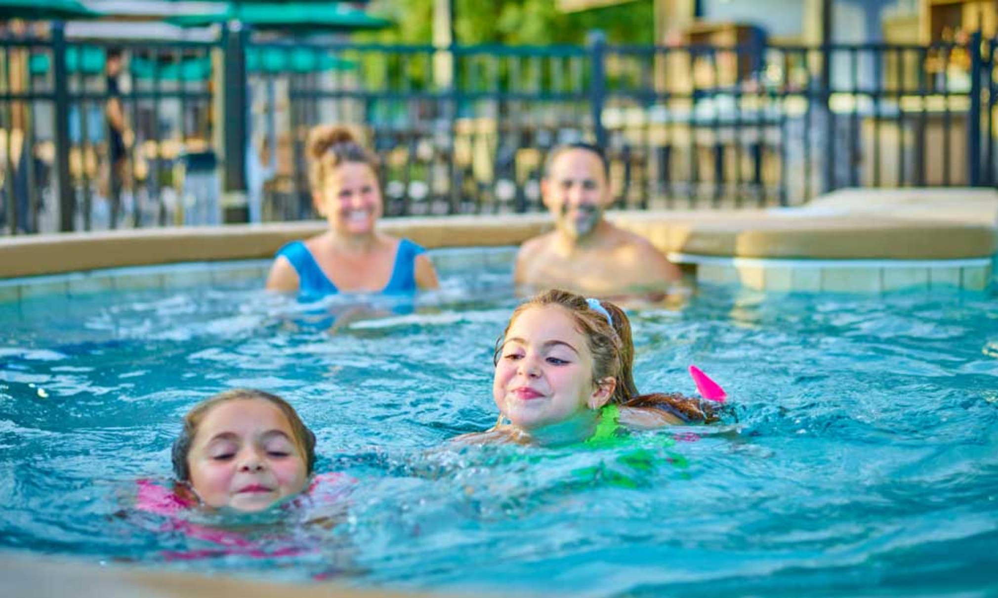 Kids and family having fun in pool