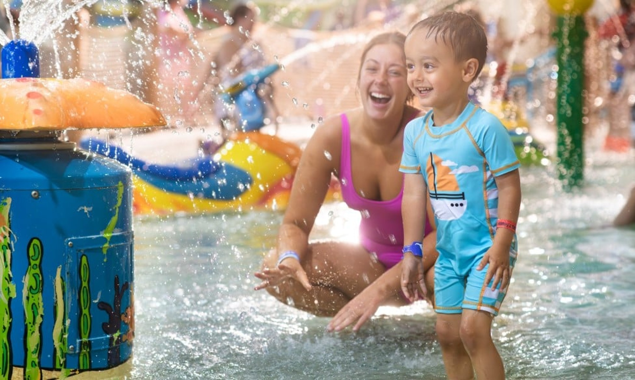 mother and child enjoying in a kidee pool in waterpark