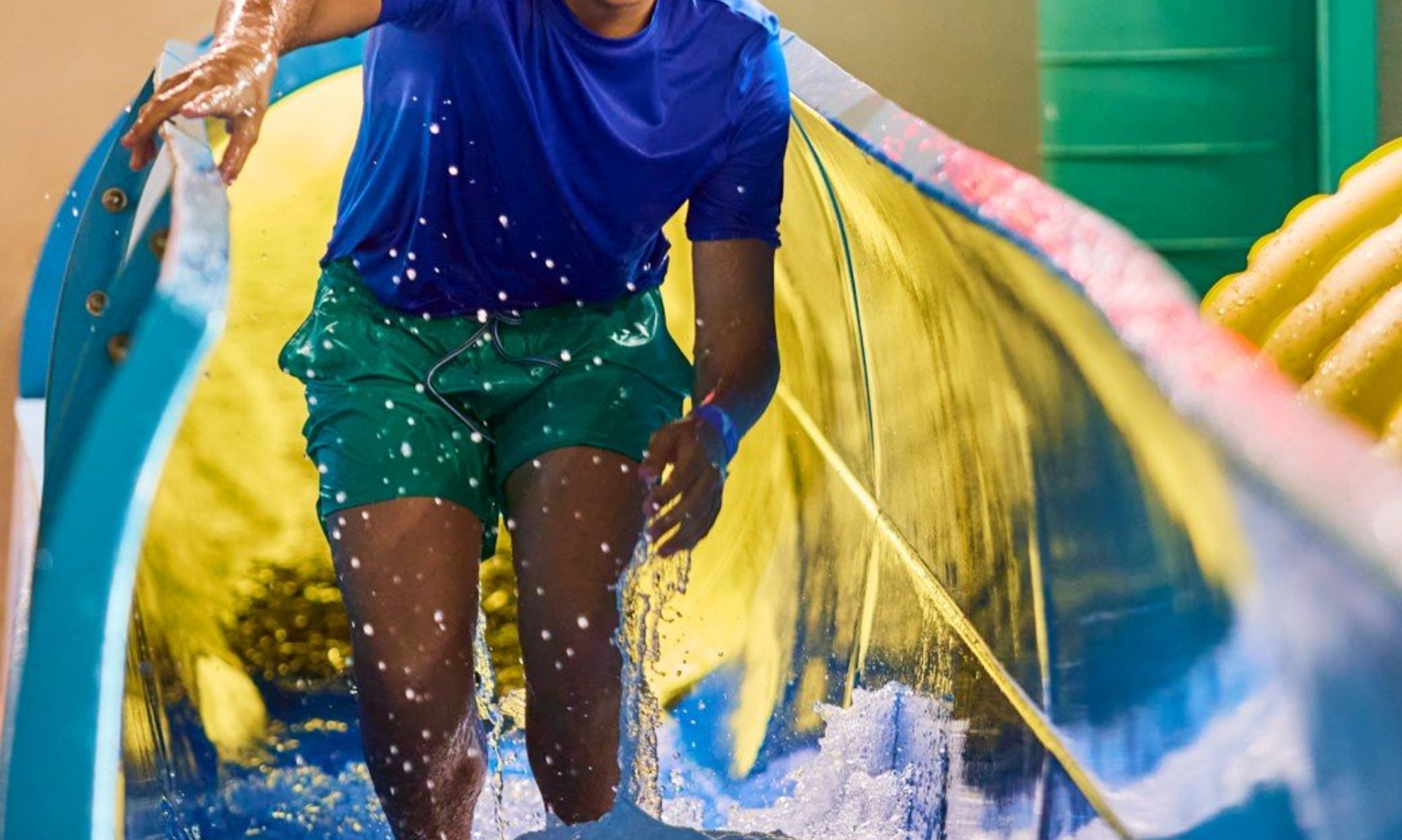 Teen enjoying water slide adventure ride