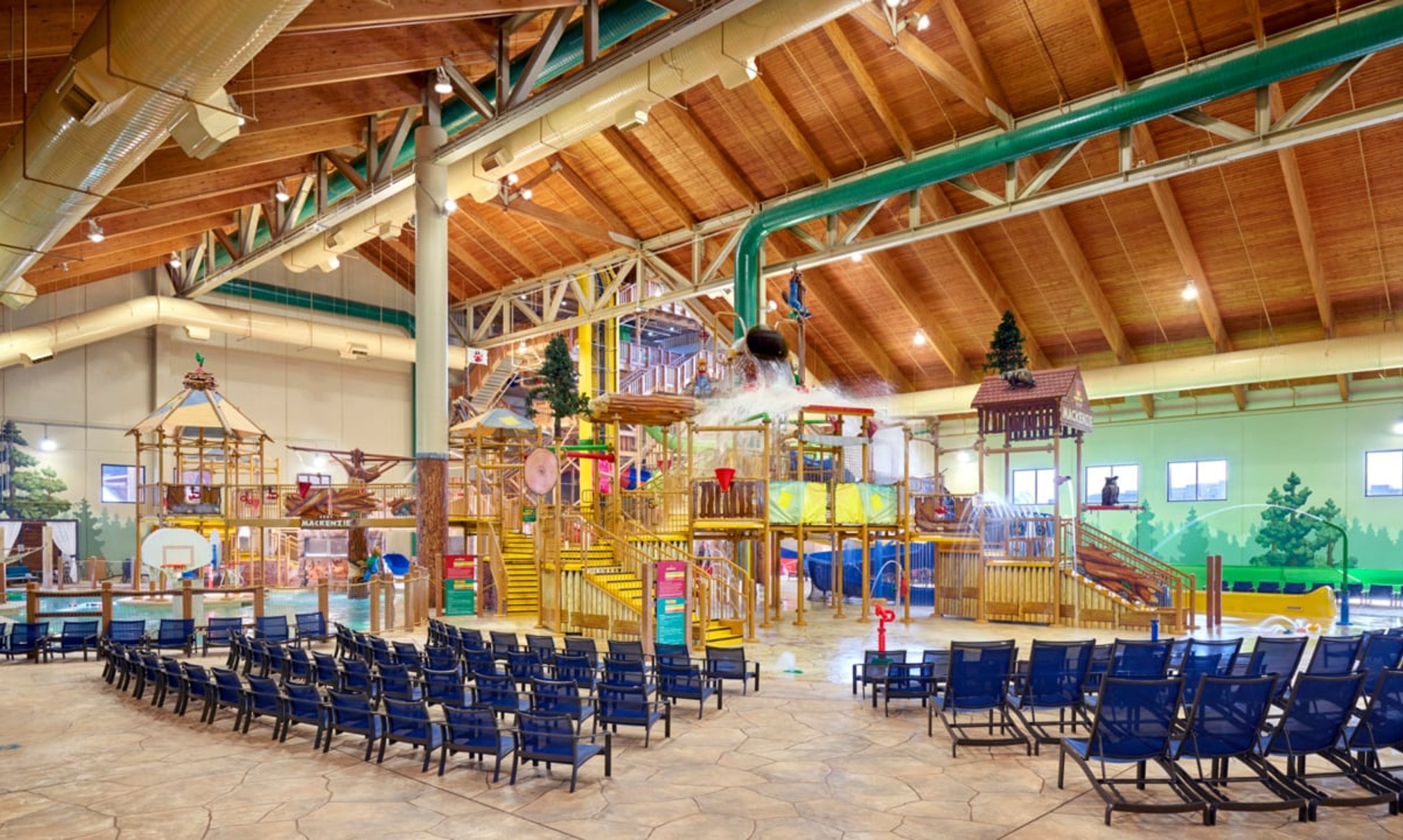 A wide shot of the  water treehouse as water splashes down from a bucket above the jungle gym