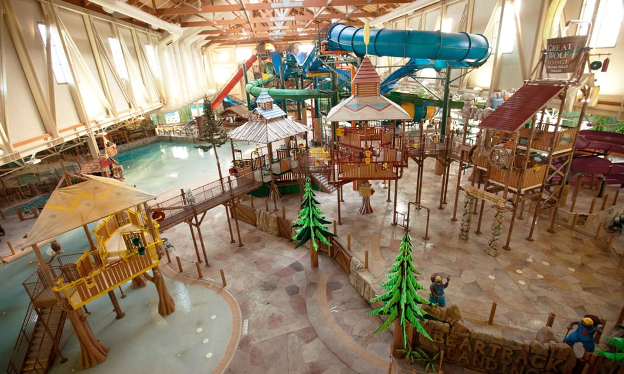 A wide shot of the  water treehouse as water splashes down from a bucket above the jungle gym