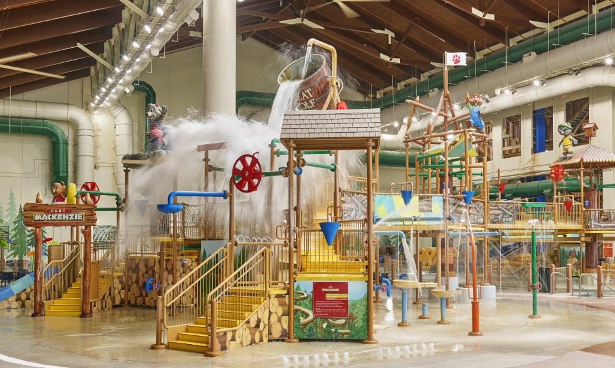 A wide shot of the  water treehouse as water splashes down from a bucket above the jungle gym