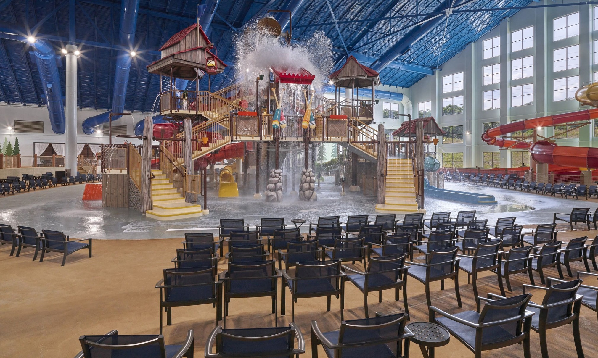 A wide shot of the water treehouse as water splashes down from a bucket