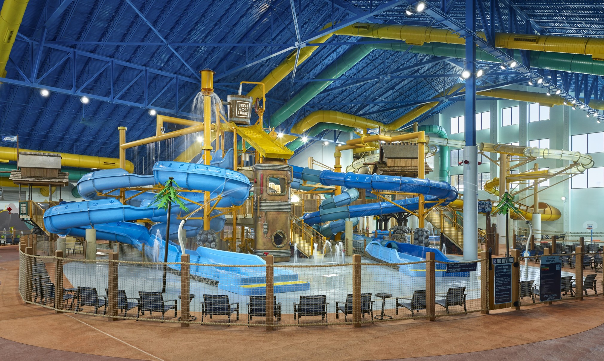 A wide shot of the  water treehouse as water splashes down from a bucket above the jungle gym