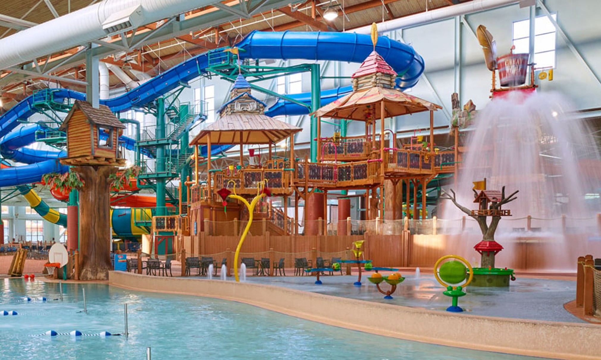 A wide shot of the water treehouse as water splashes down from a bucket
