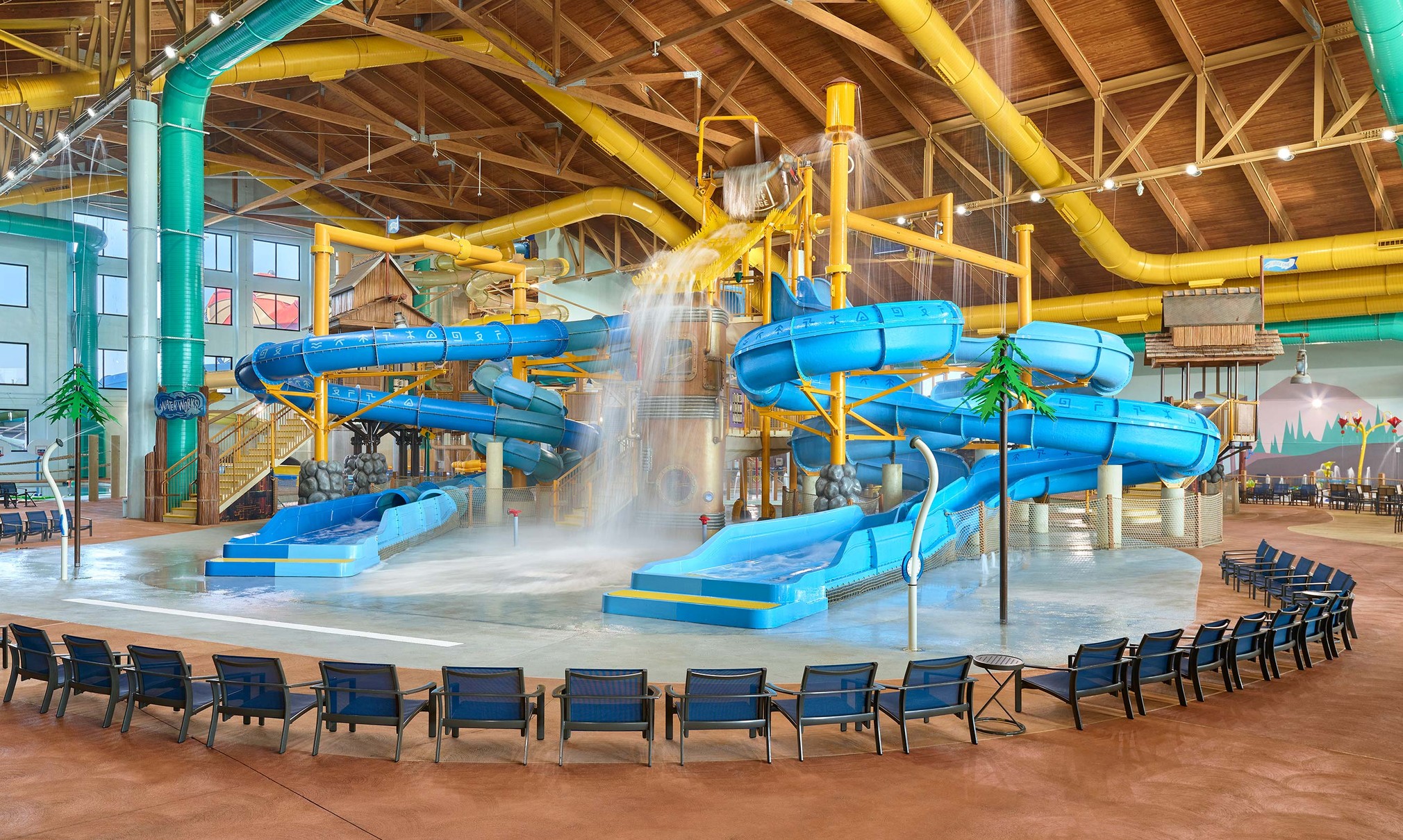 A wide shot of the water treehouse as water splashes down from a bucket