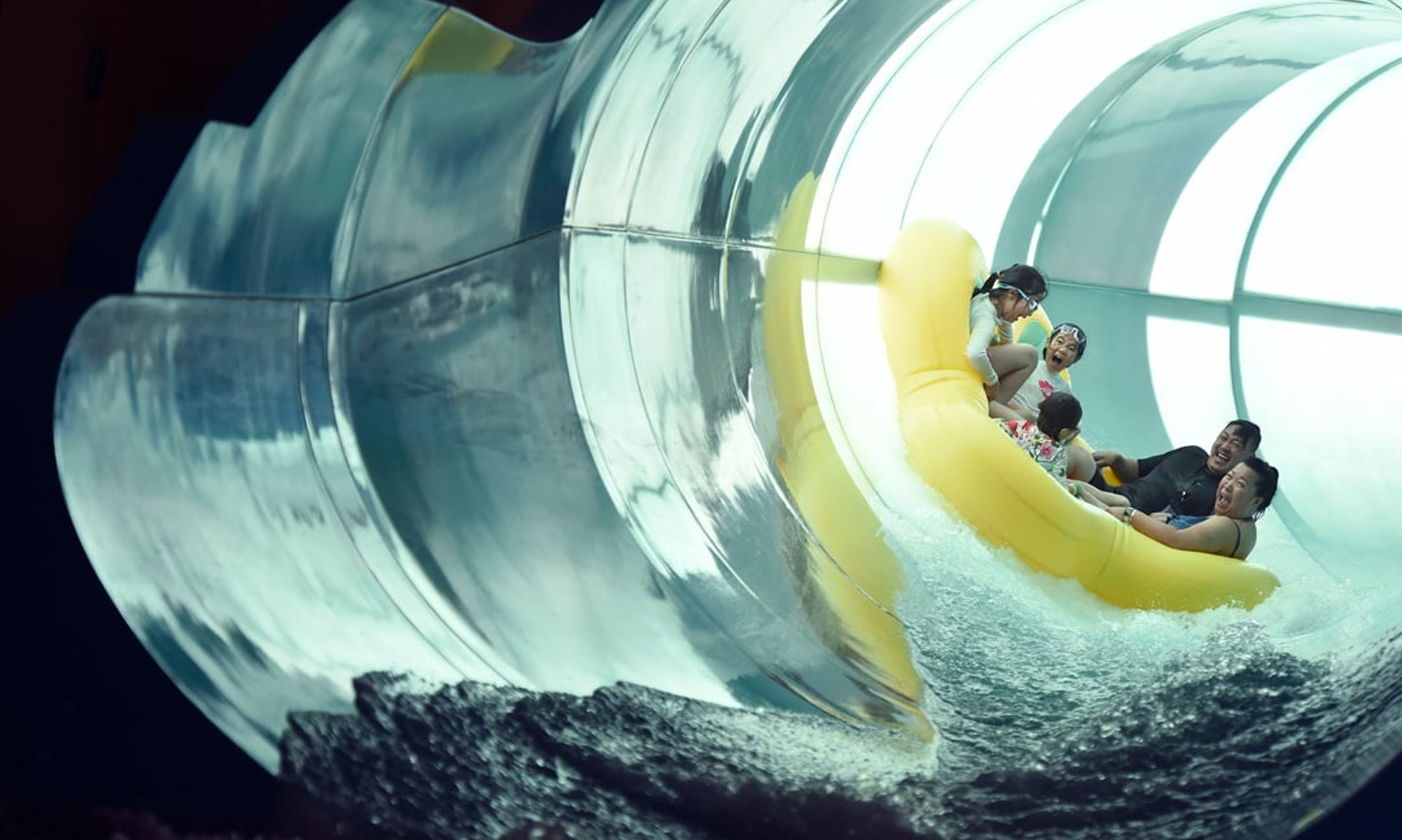 Family of five rides down enclosed waterslide 