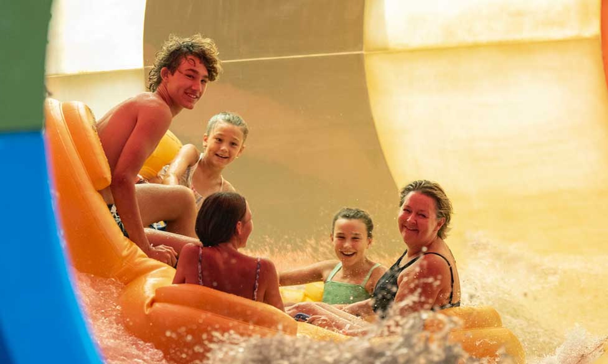 Family of five rides down enclosed waterslide 