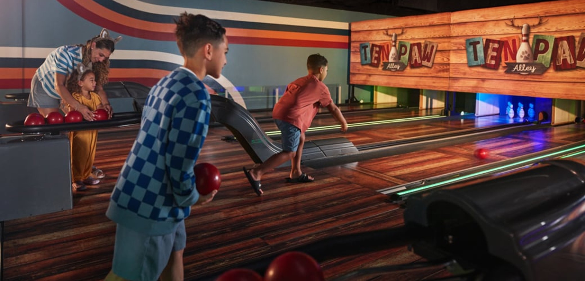 Boy smiling while playing bowling