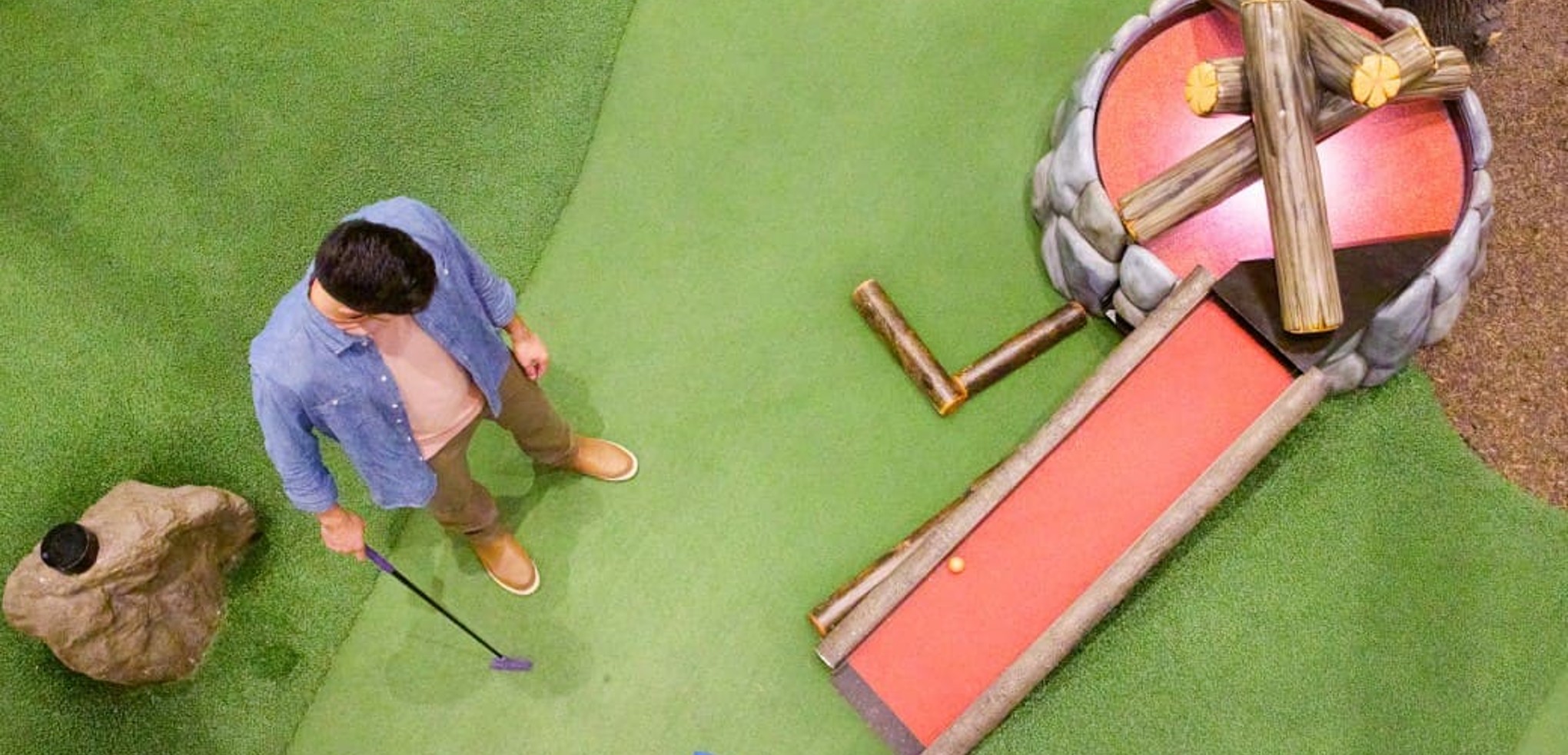 Family play a round of mini golf