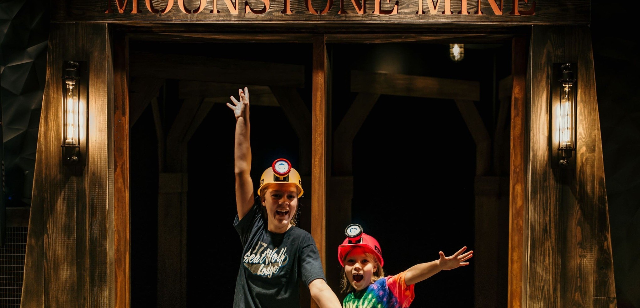 Two kids posing excitedly in front of Moonstone Mine