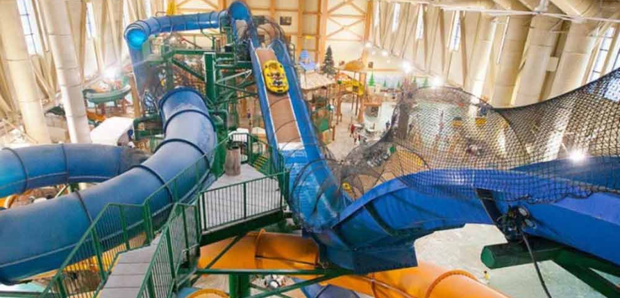 Wide view of the Niagara Rapids Run's multiple tube slides at Great Wolf Lodge indoor water park and resort.