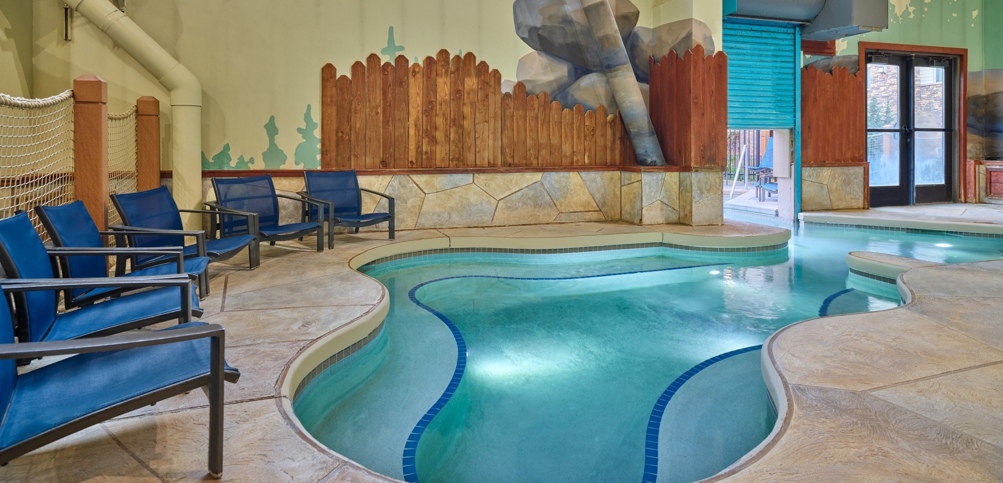 A family of four relaxes in the indoor pool