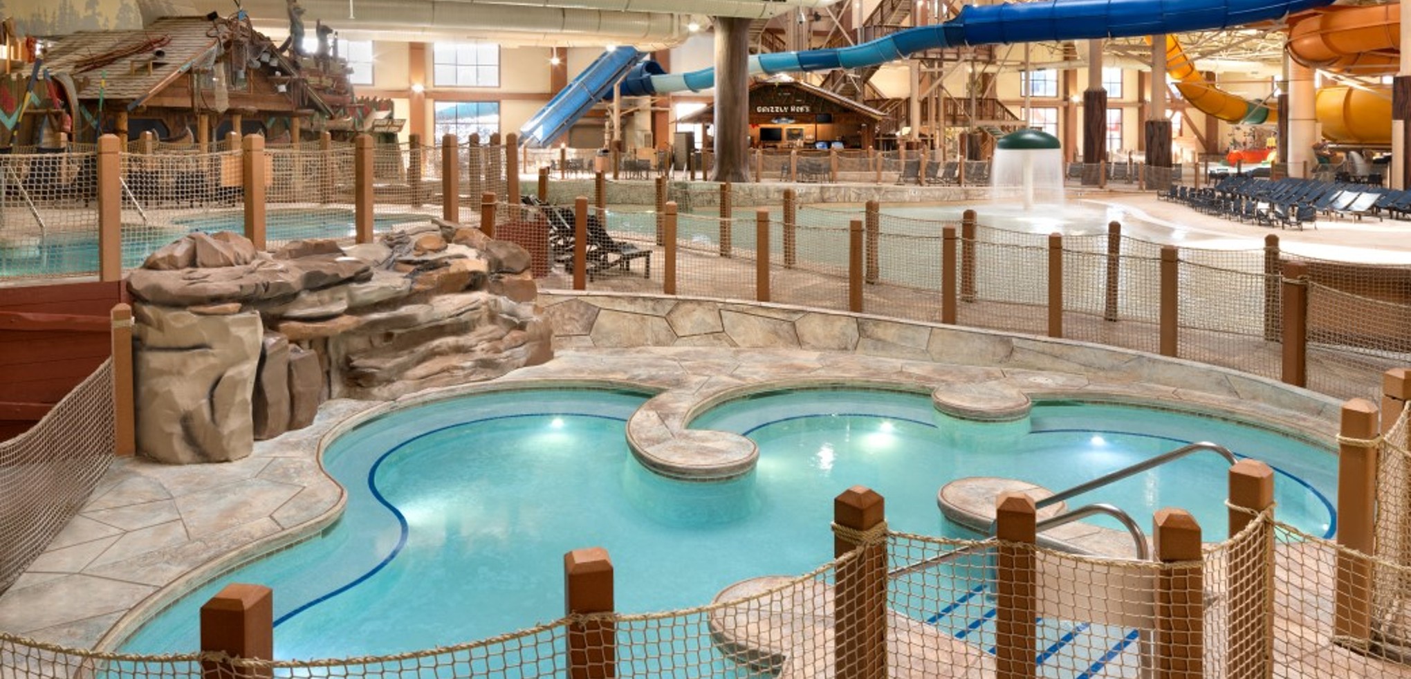 A family of four relaxes in the indoor pool