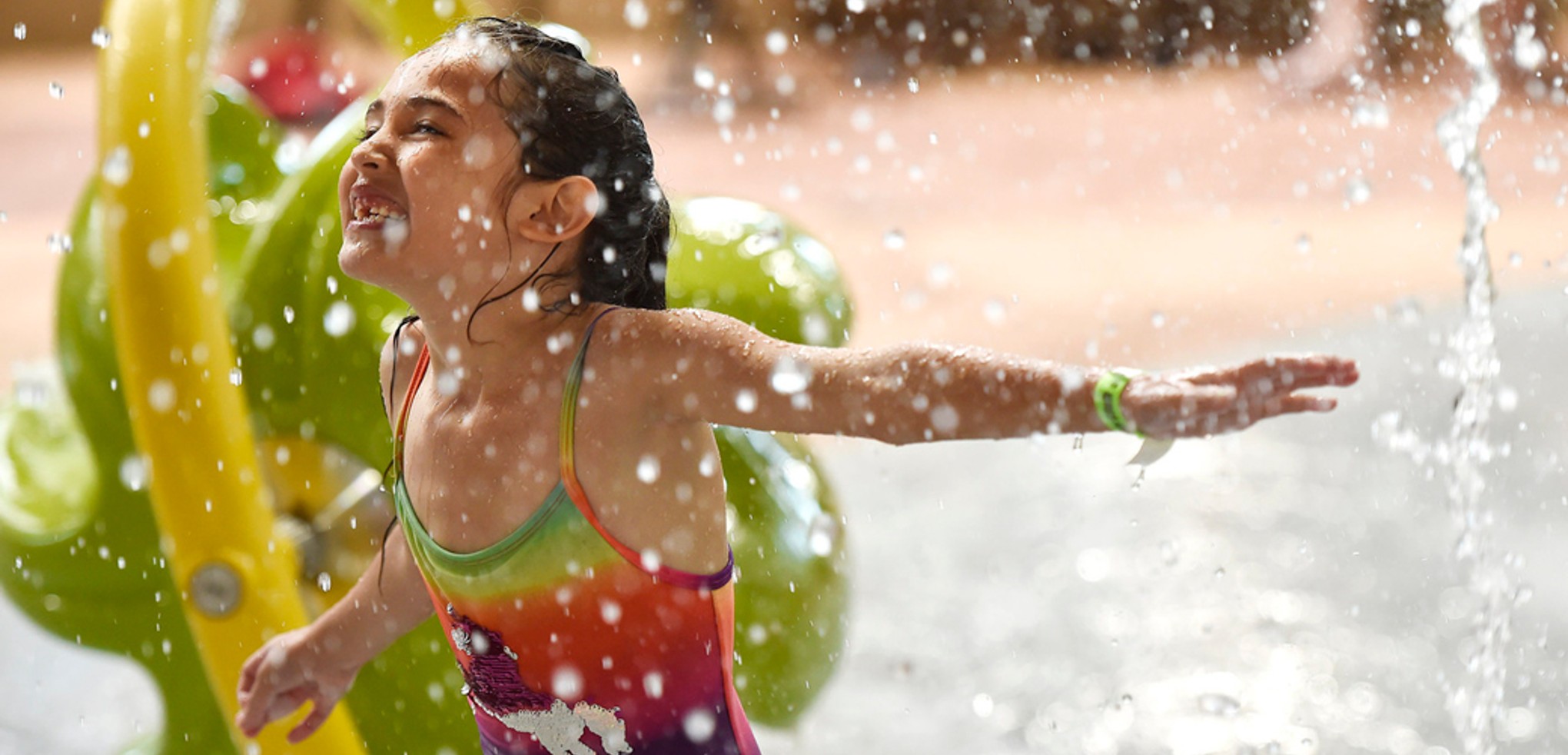 Little girl enjoying cub paw pool