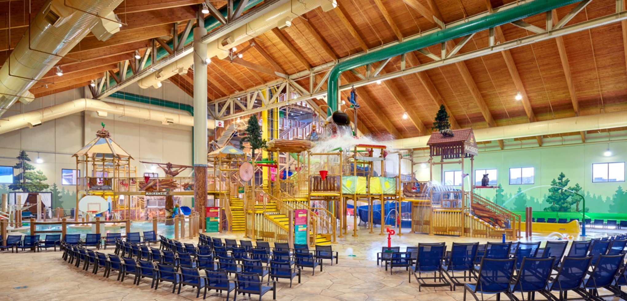 A wide shot of the  water treehouse as water splashes down from a bucket above the jungle gym