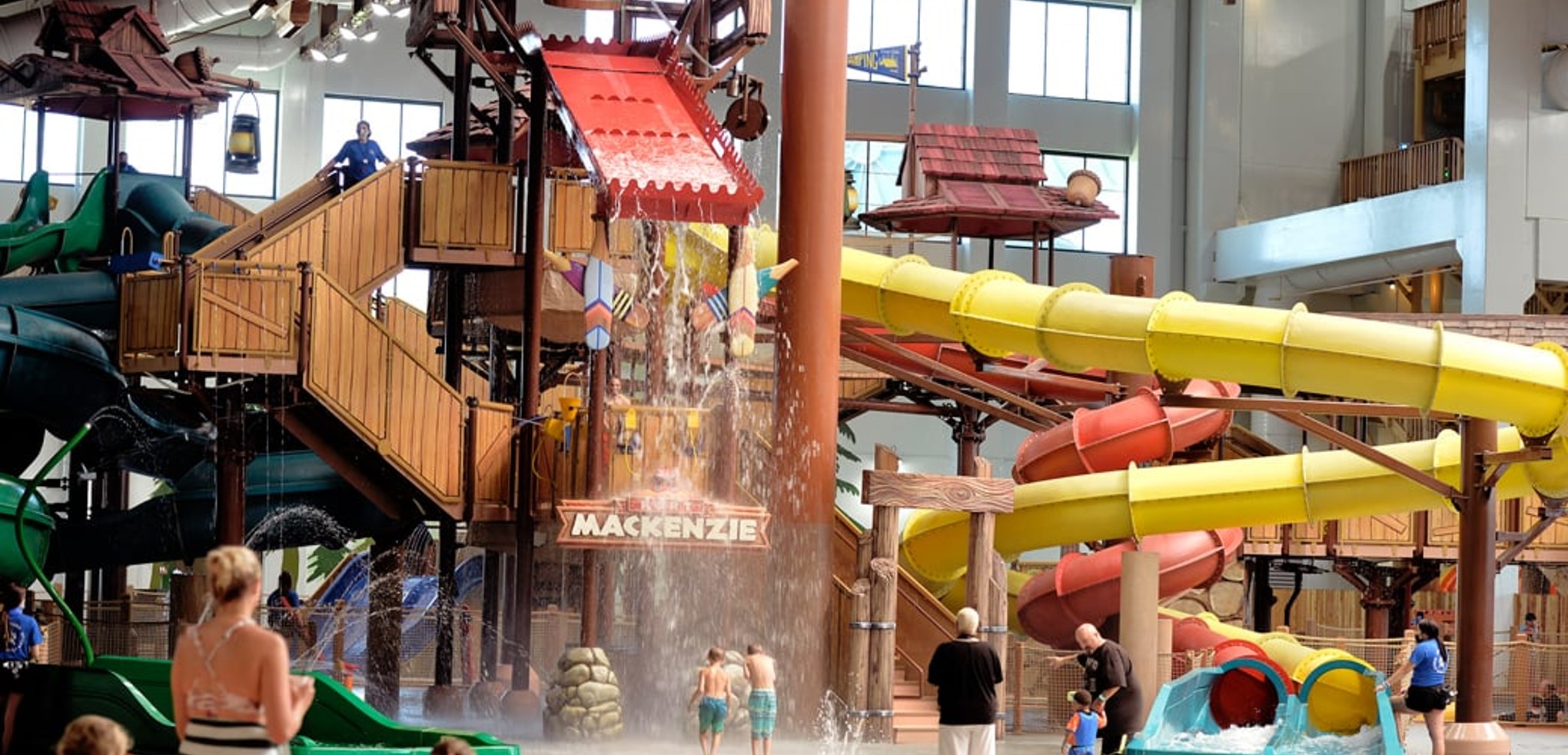 A wide shot of the  water treehouse as water splashes down from a bucket above the jungle gym