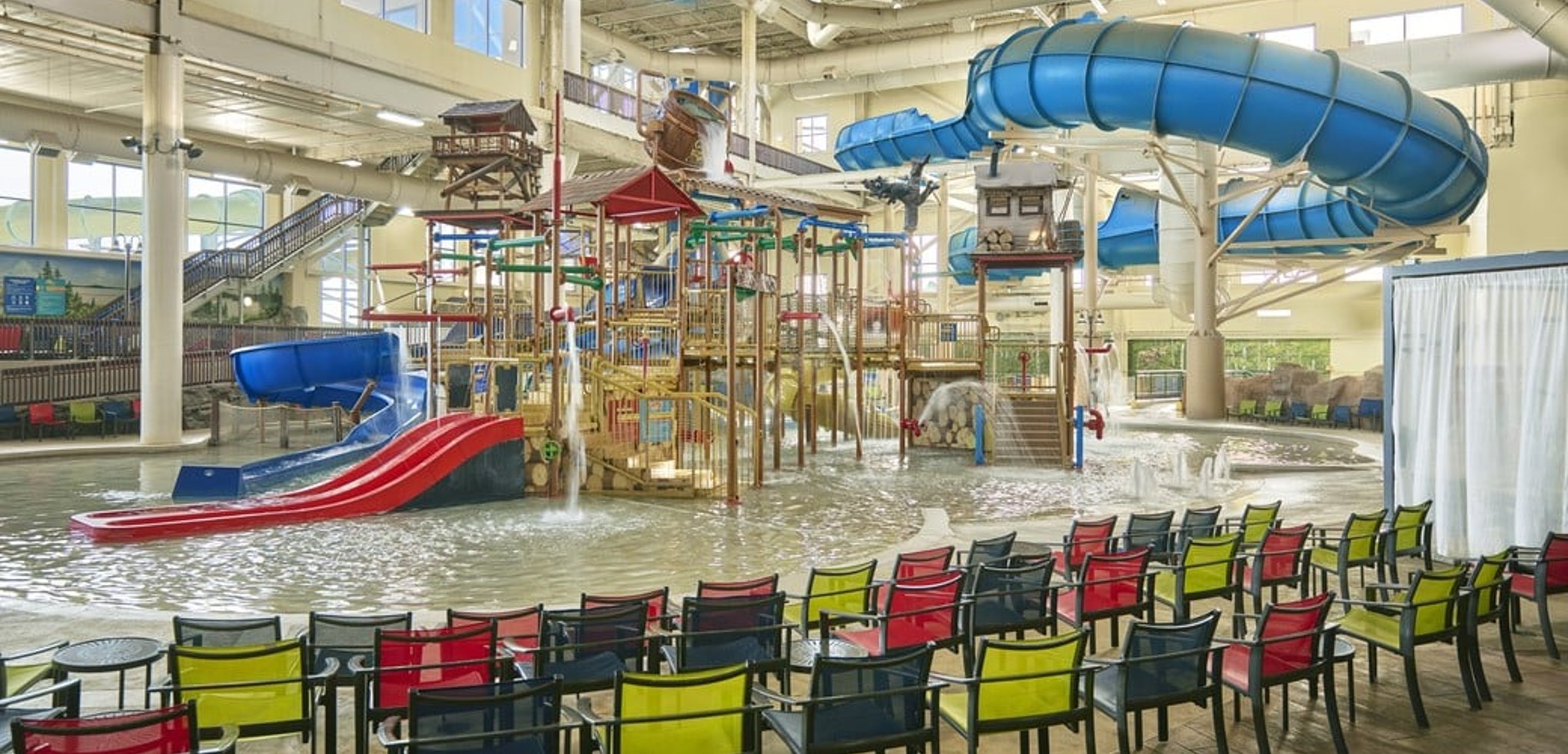 A wide shot of the  water treehouse as water splashes down from a bucket above the jungle gym