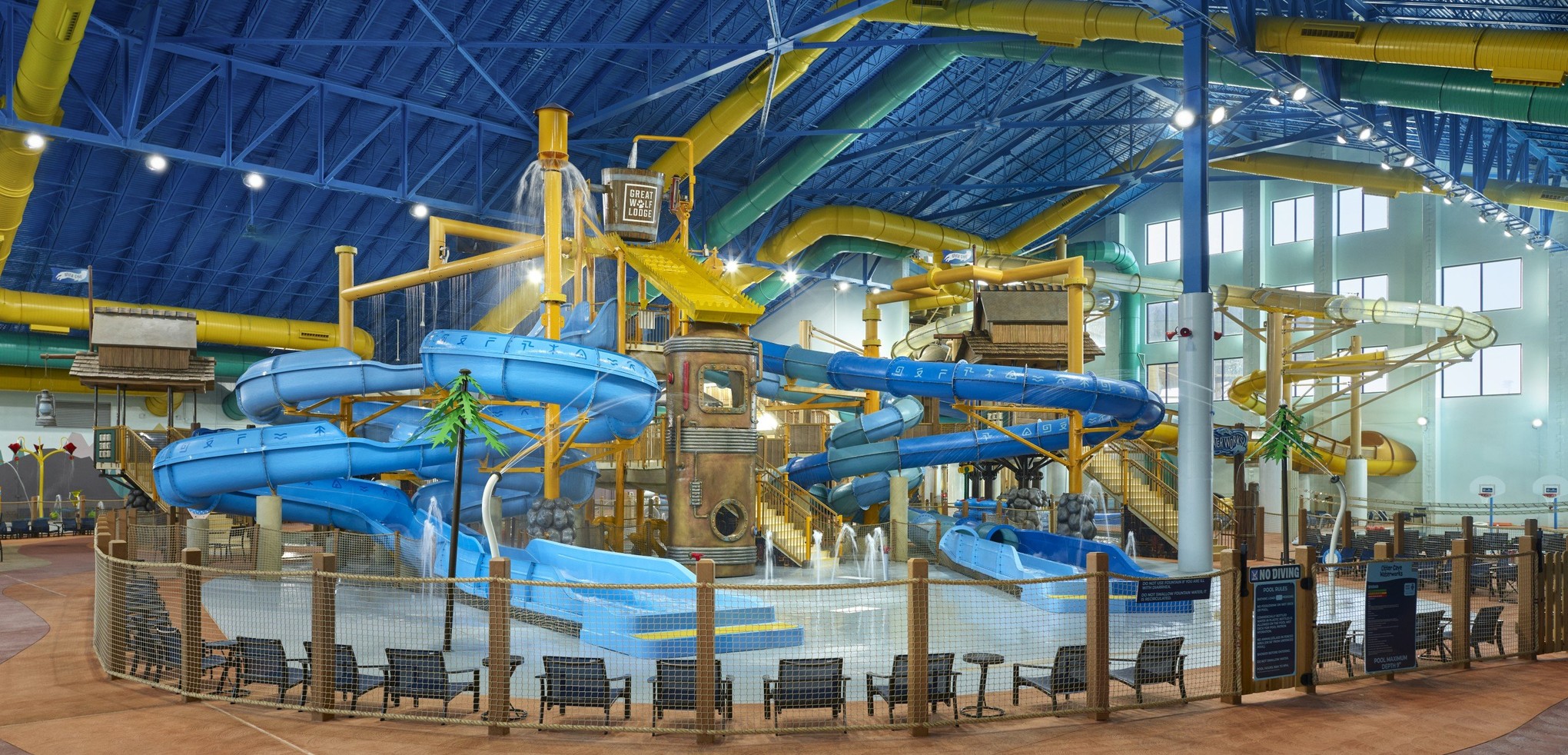 A wide shot of the  water treehouse as water splashes down from a bucket above the jungle gym