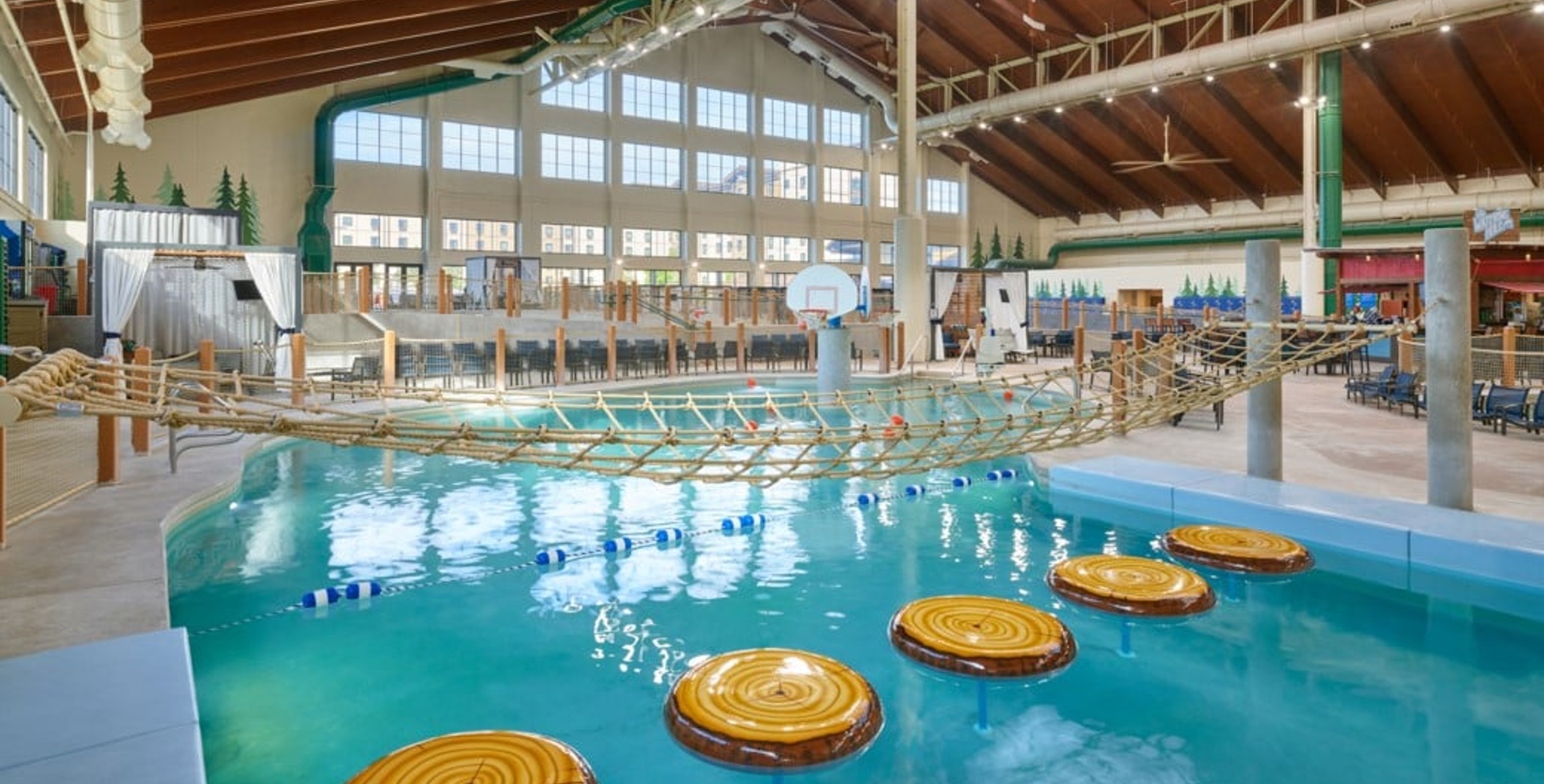 family playing basketball in indoor pool 