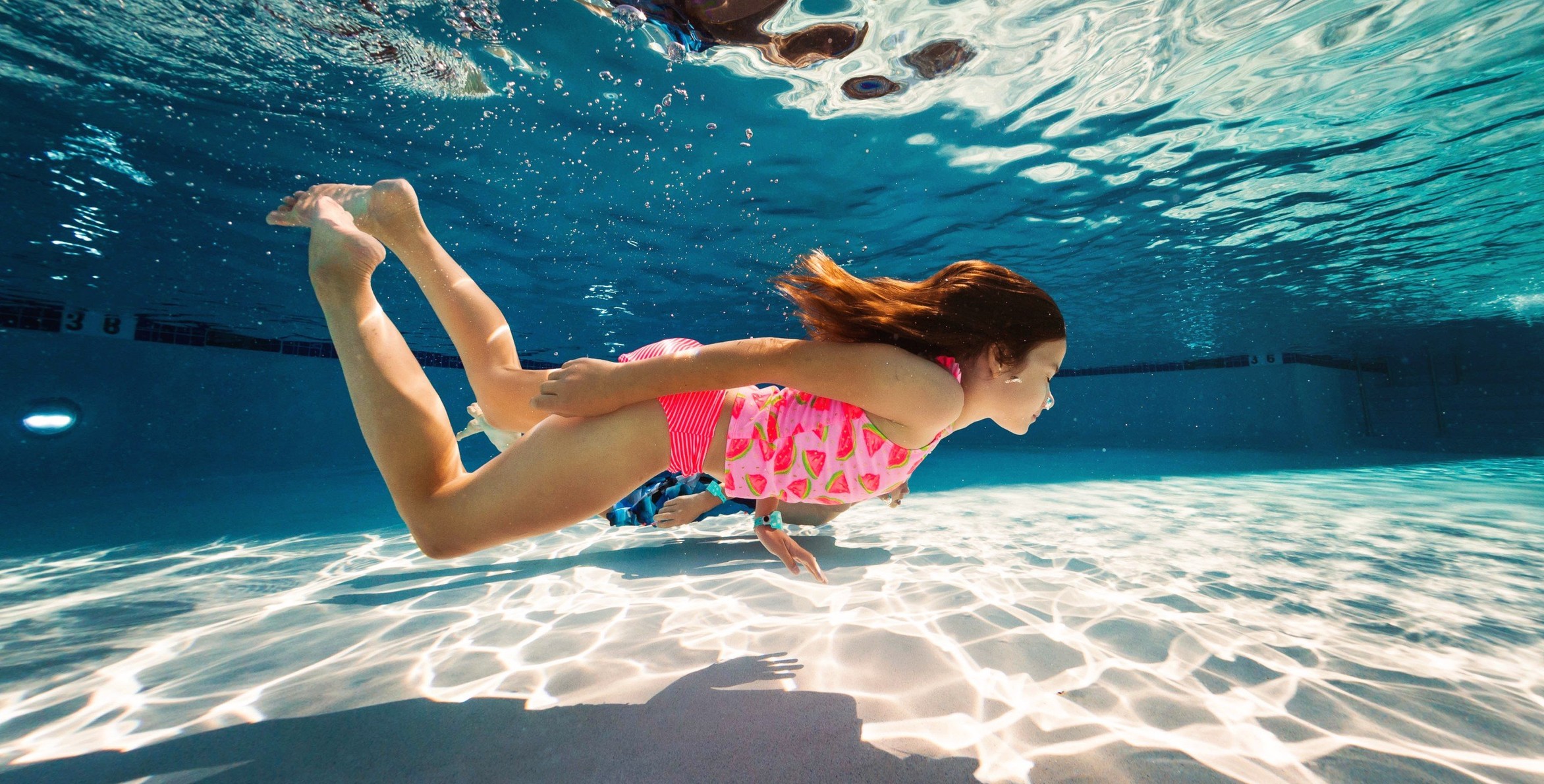 girl swimming under water