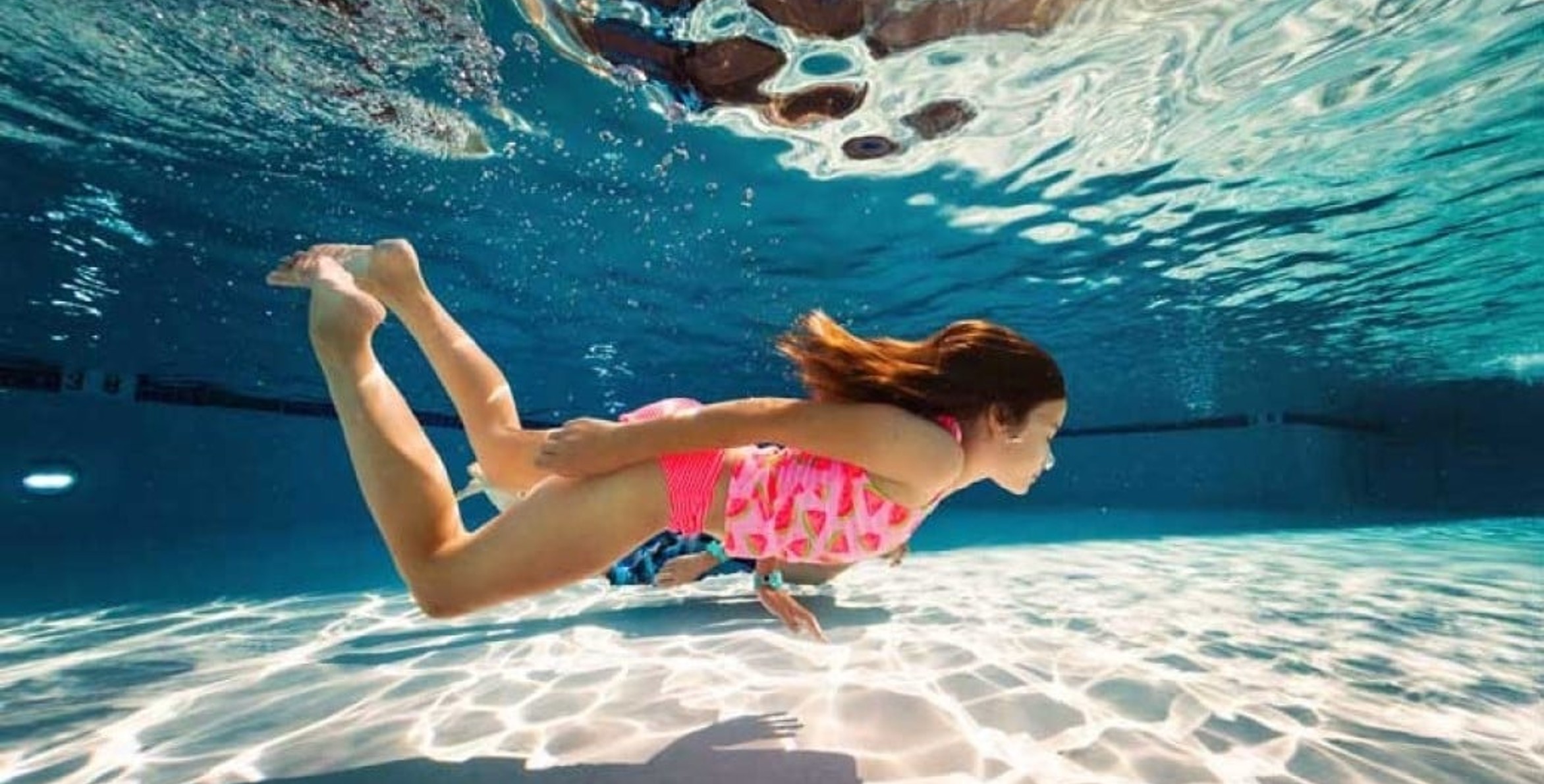 girl swimming under water