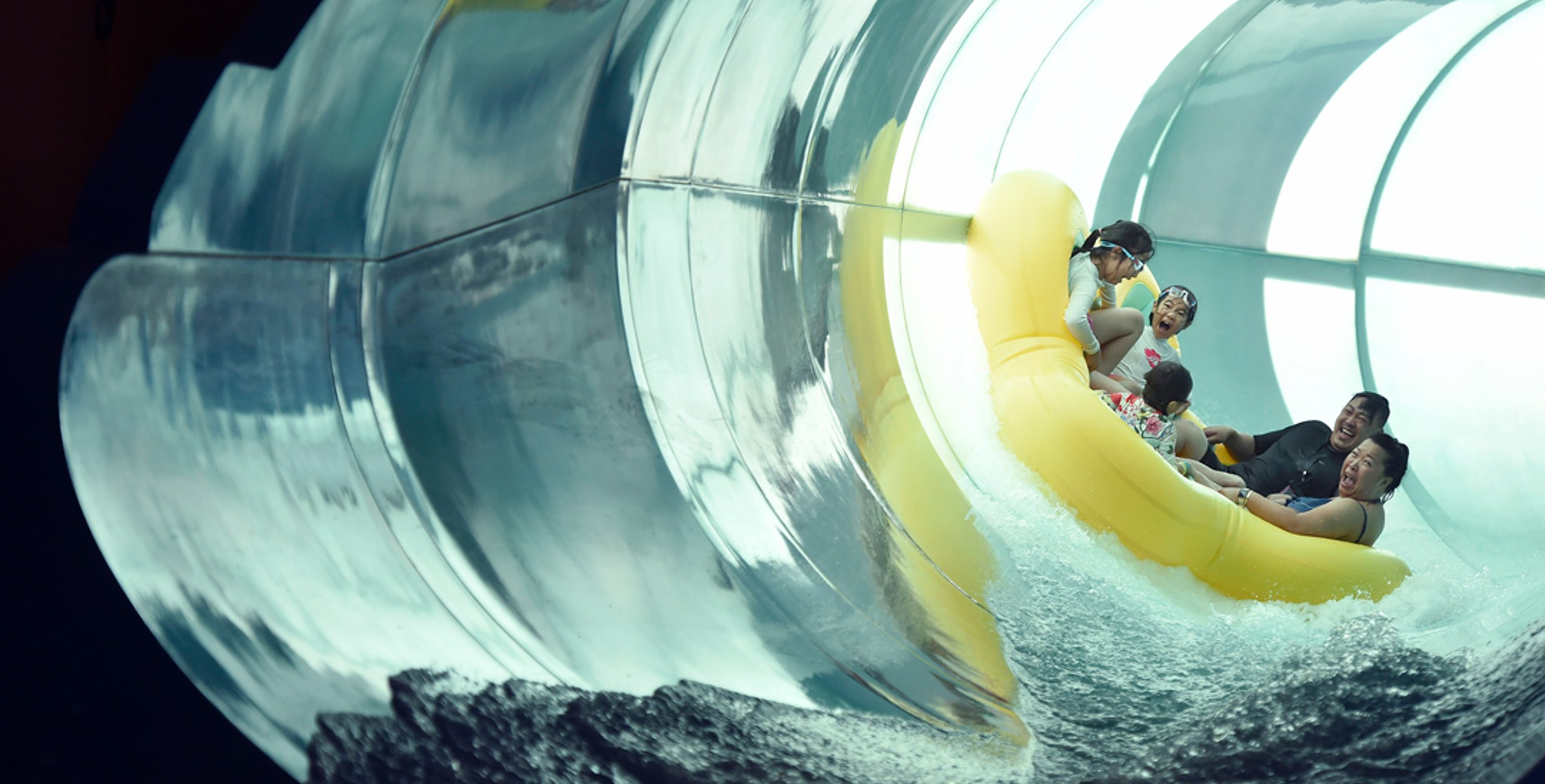 Family of five rides down enclosed waterslide 