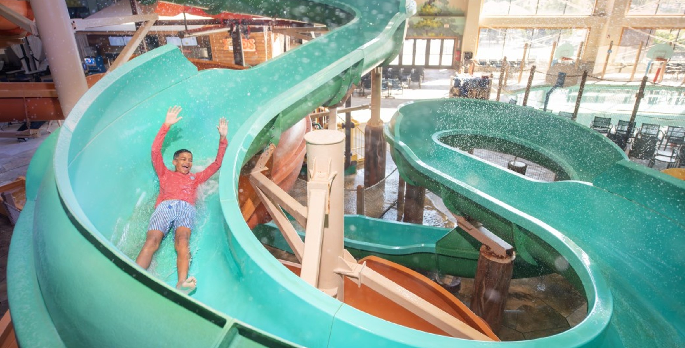 kid rides down waterslide