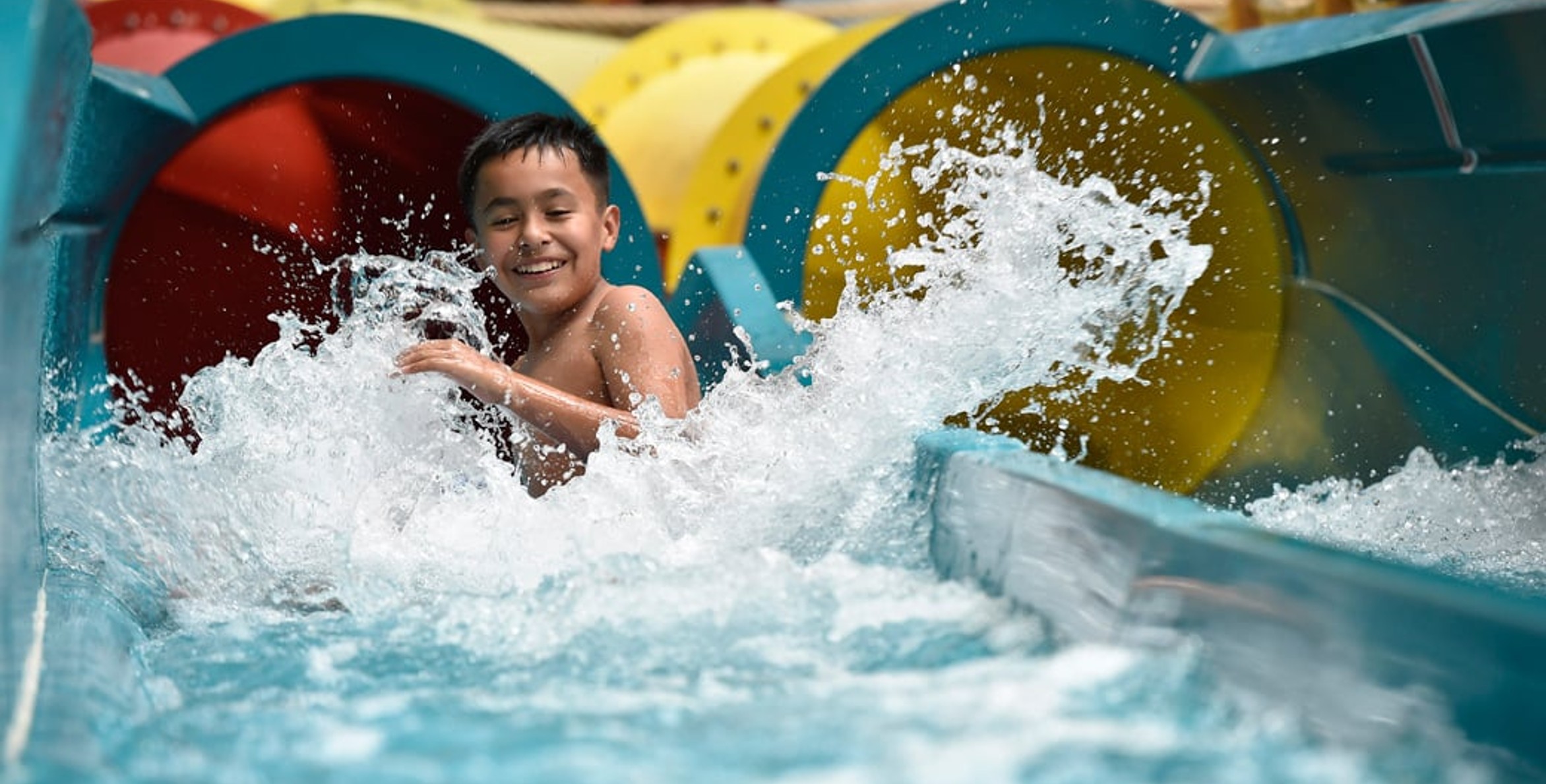 kid rides down waterslide