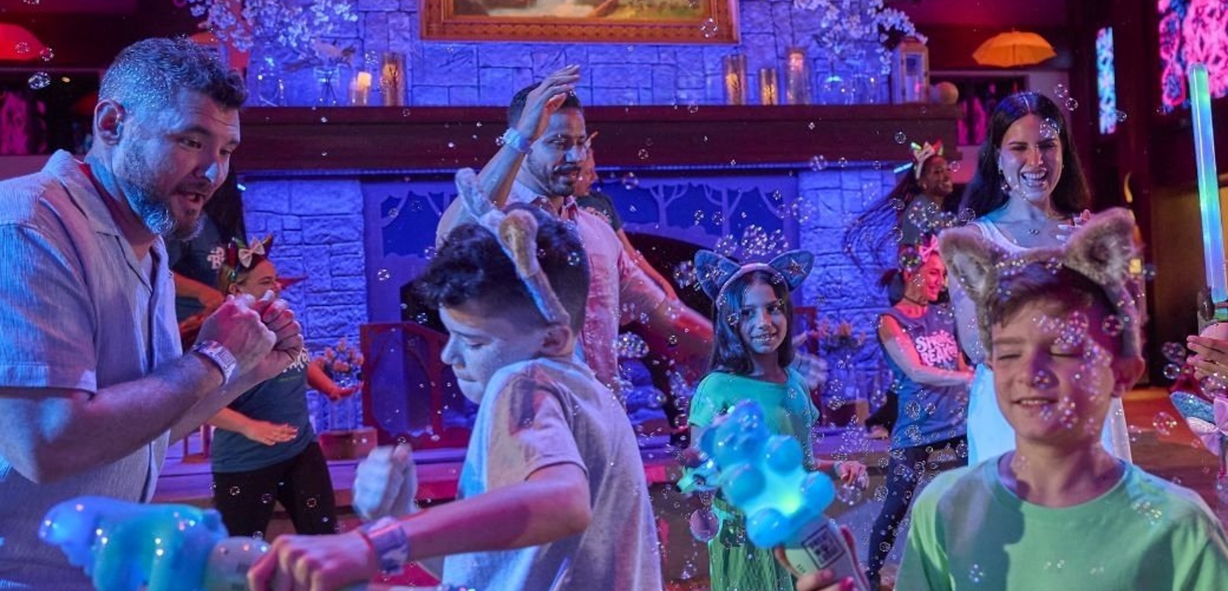 A family dancing and playing with bubbles in a fun setting