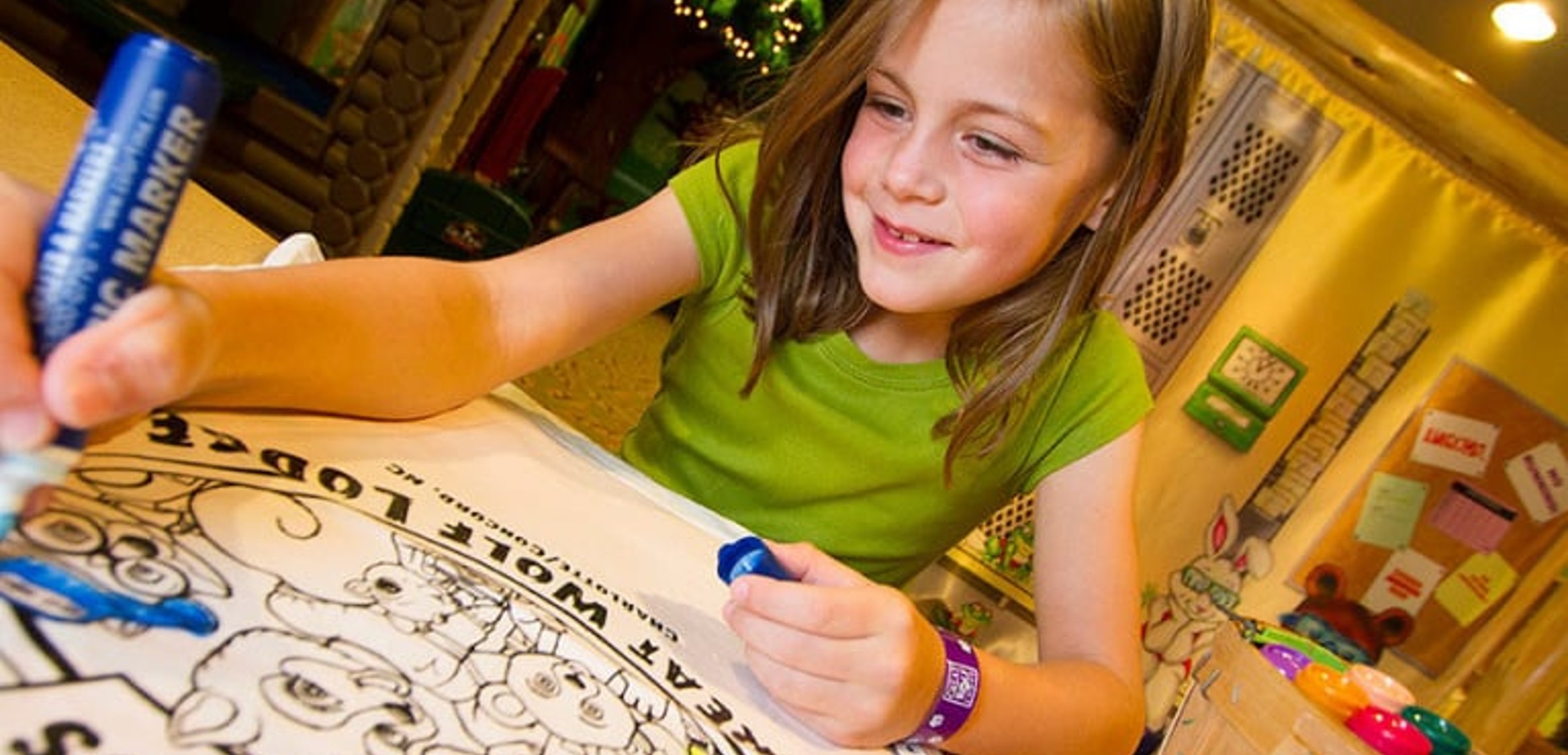 A girl uses markers to color at Great Wolf Lodge indoor water park and resorts.
