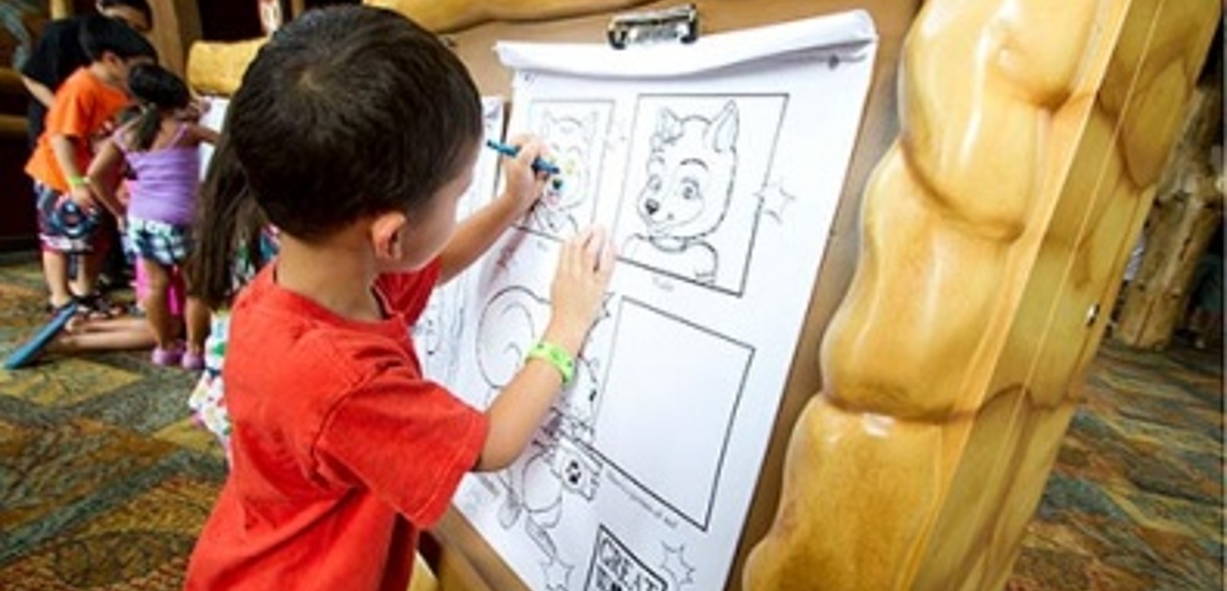 A young child draws at an event at Great Wolf Lodge indoor water park and resorts.