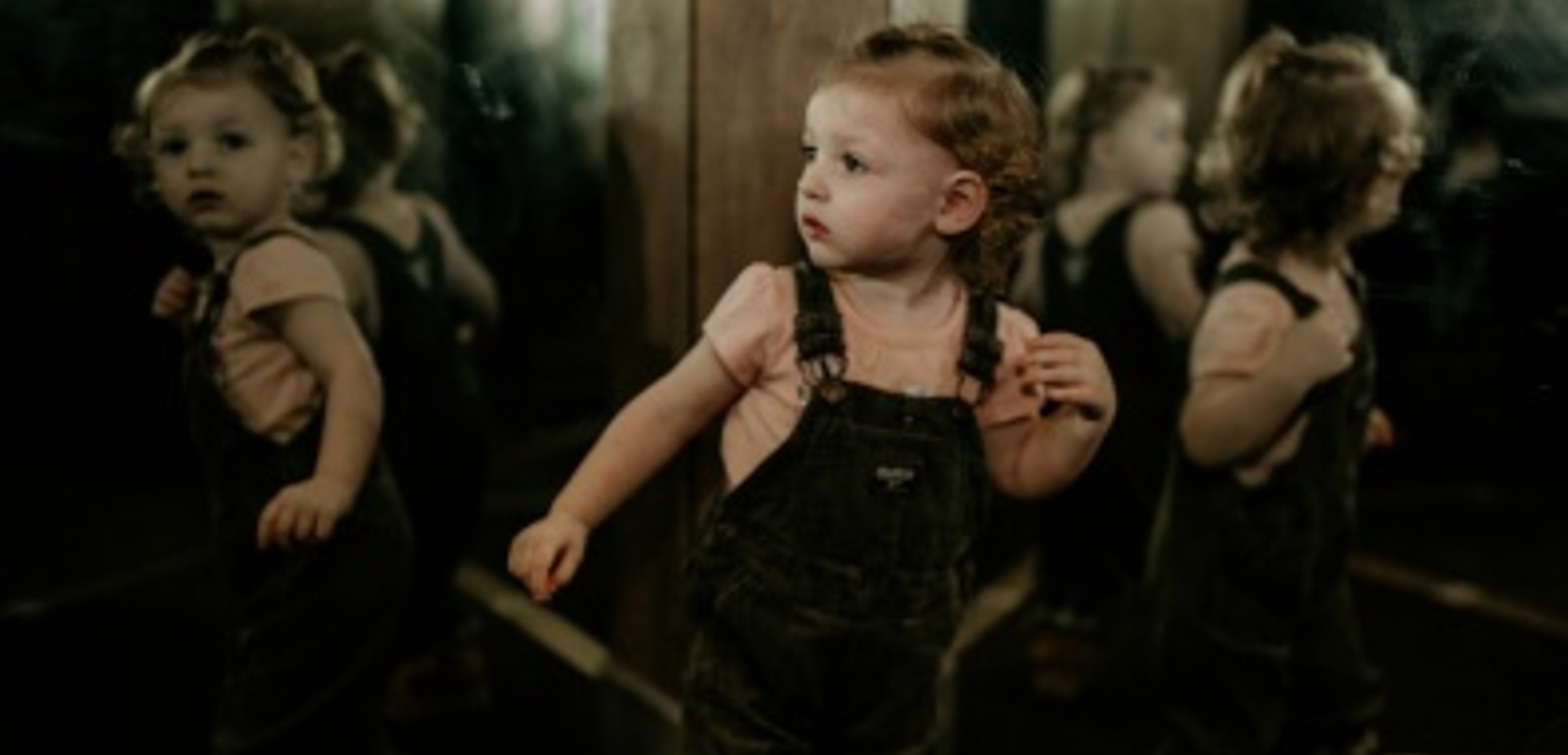 A girl looks at mirrors in Moonstone Mine at Great Wolf Lodge indoor water park and resort.