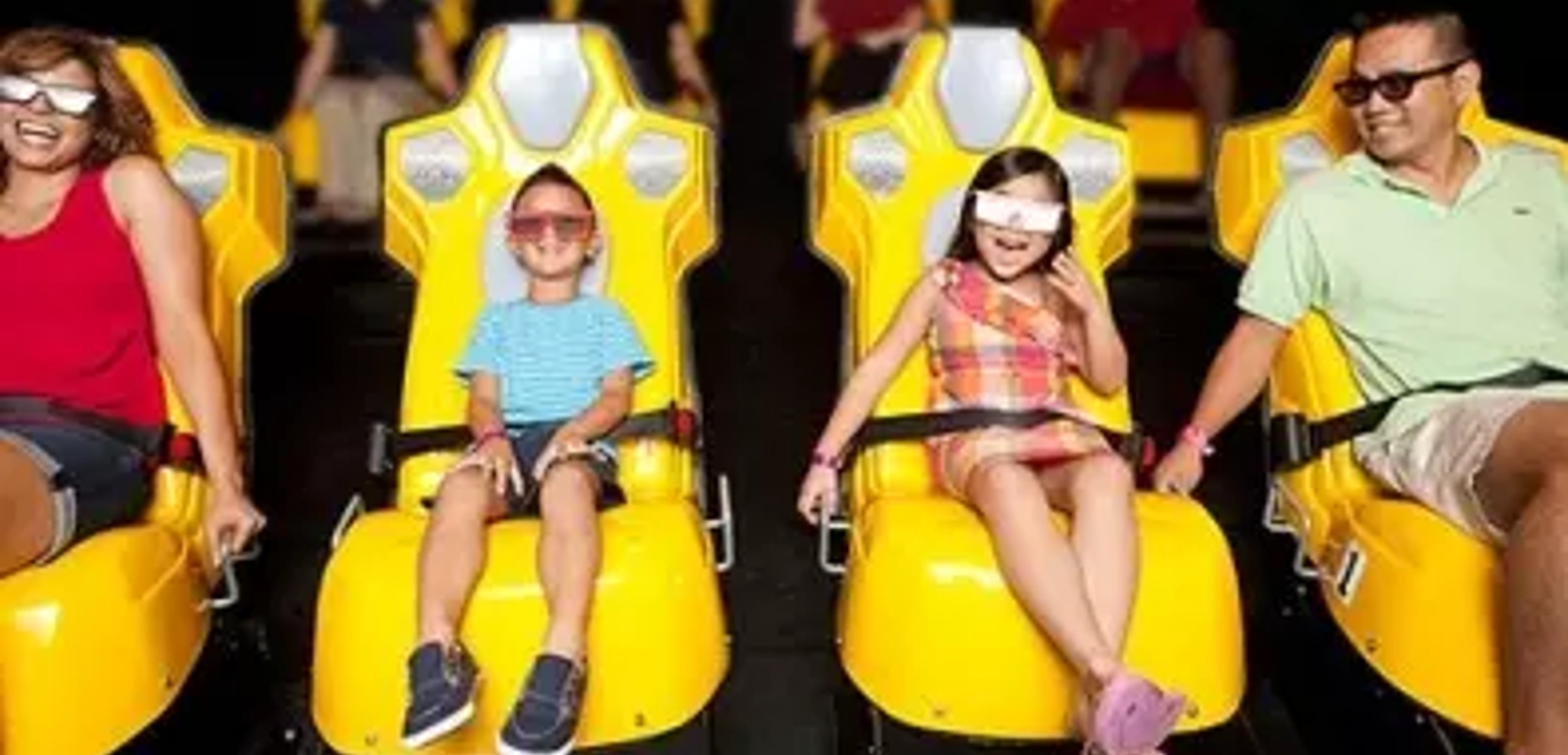 A family of four wear 3D glasses inside the Howly Wood XD Theater at Great Wolf Lodge indoor water park and resort.