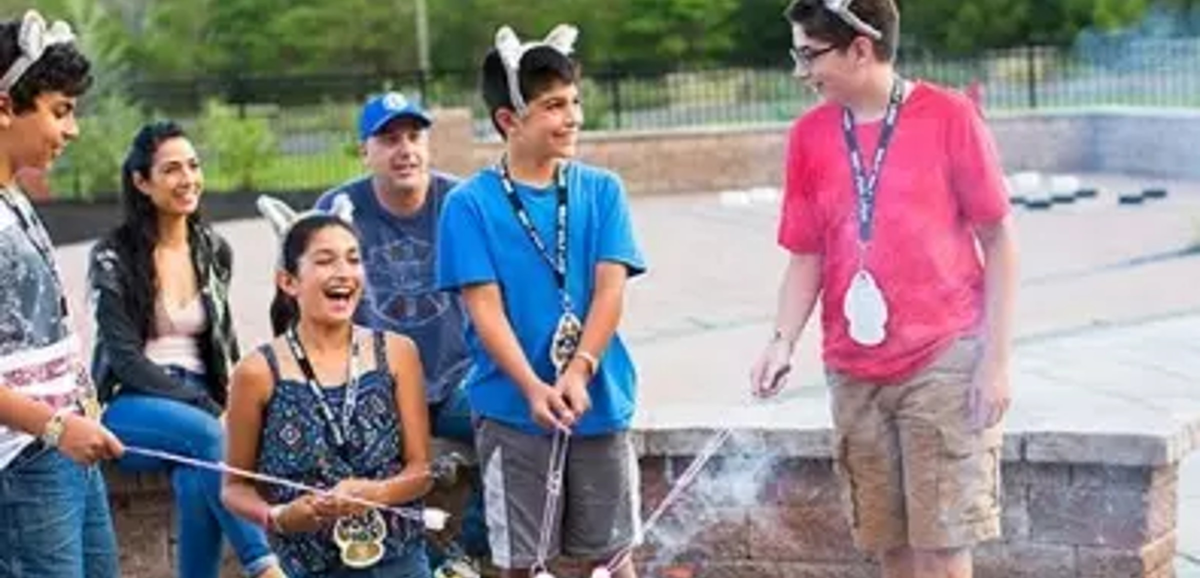 A family roasts s'mores outdoors