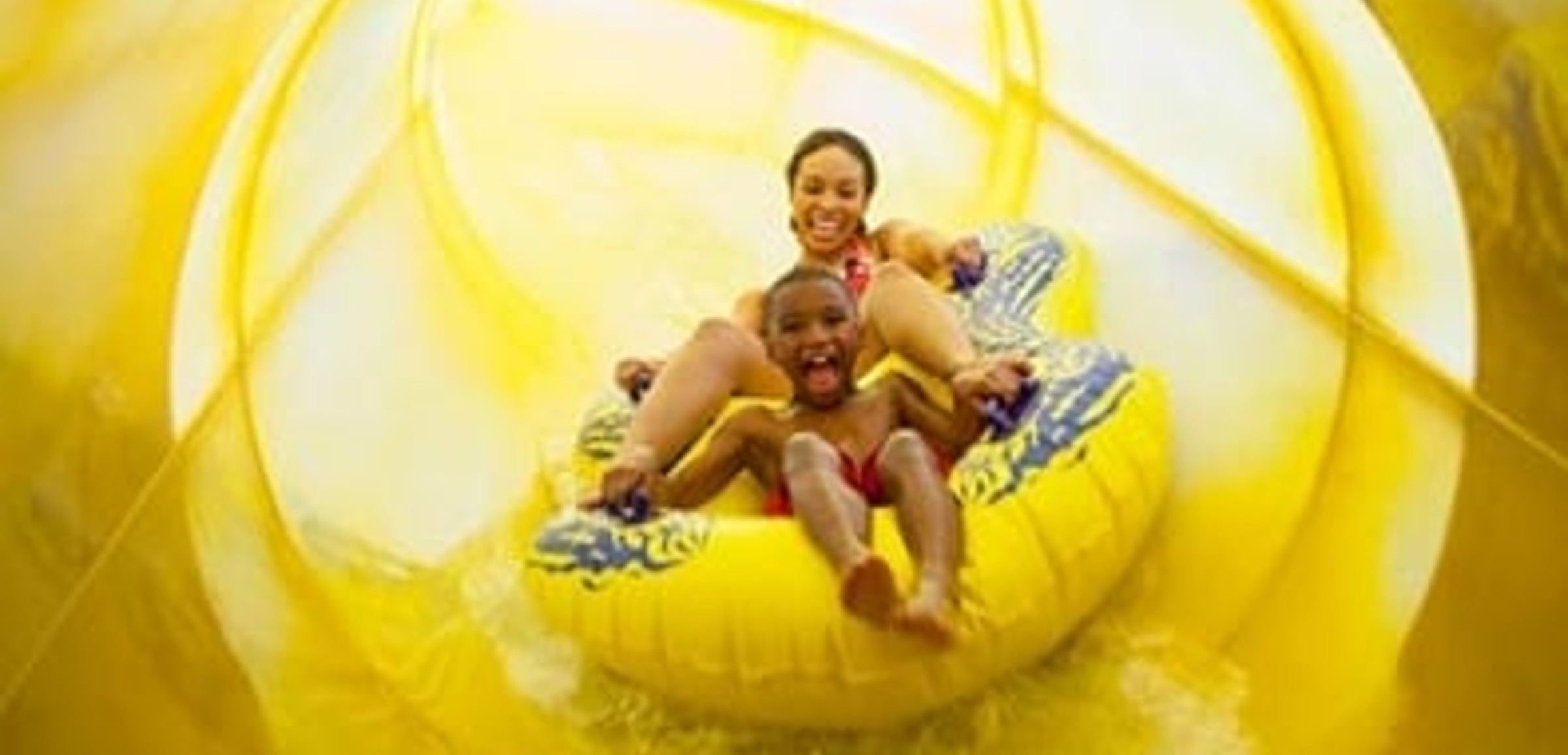 Mother and son rafting down the exciting Alberta Falls water slide 