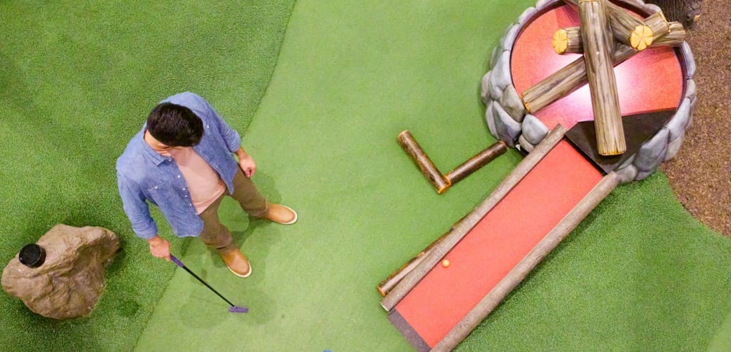 Family play a round of mini golf
