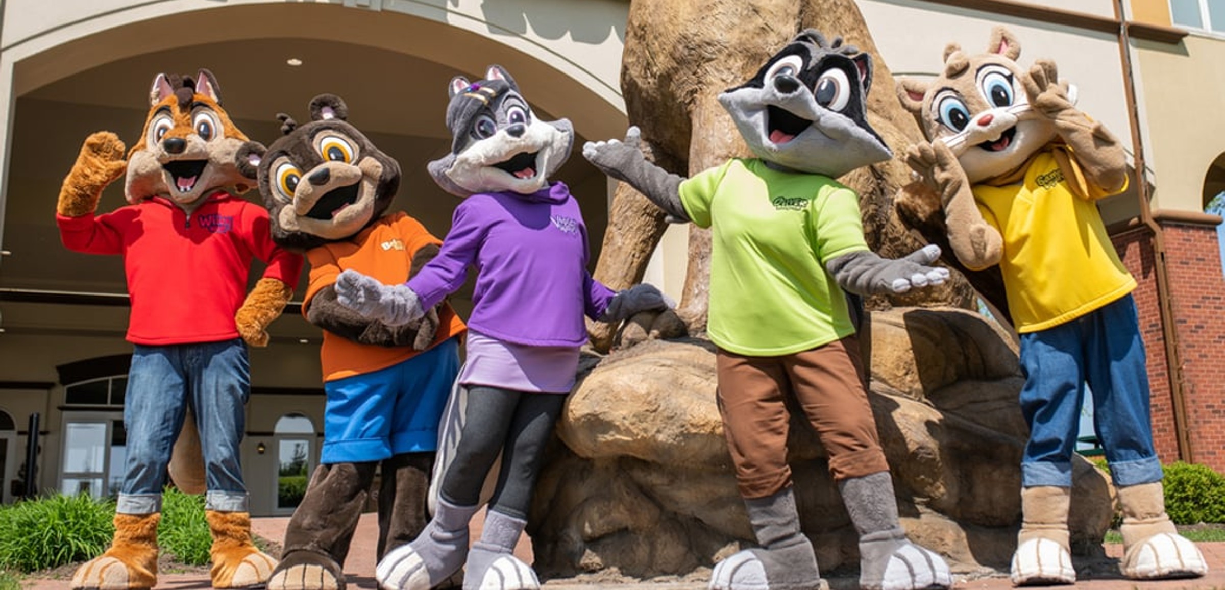 Great wolf lodge characters in front of a lodge