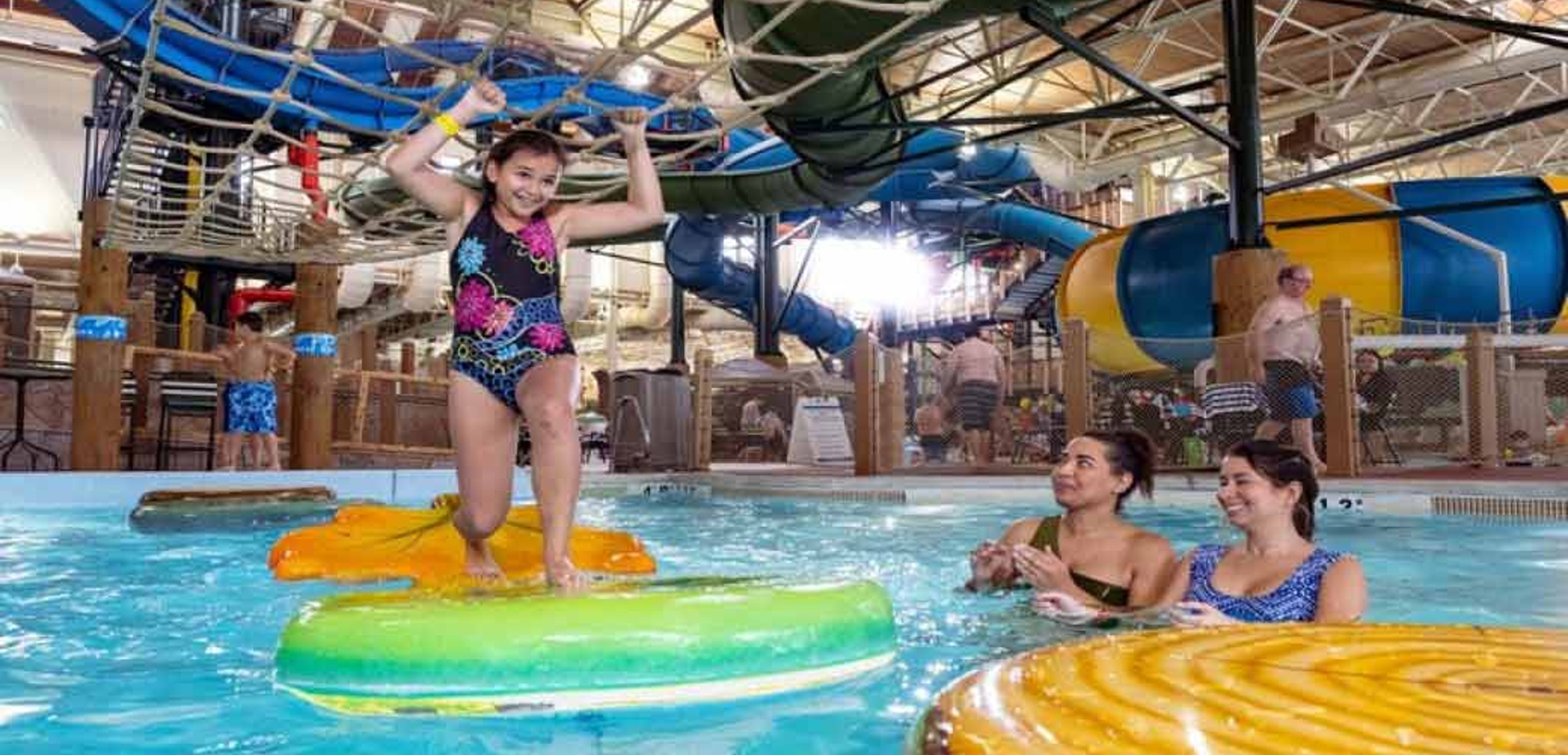 A child balances on a lilly pad at Great Wolf Lodge indoor water park and resort.
