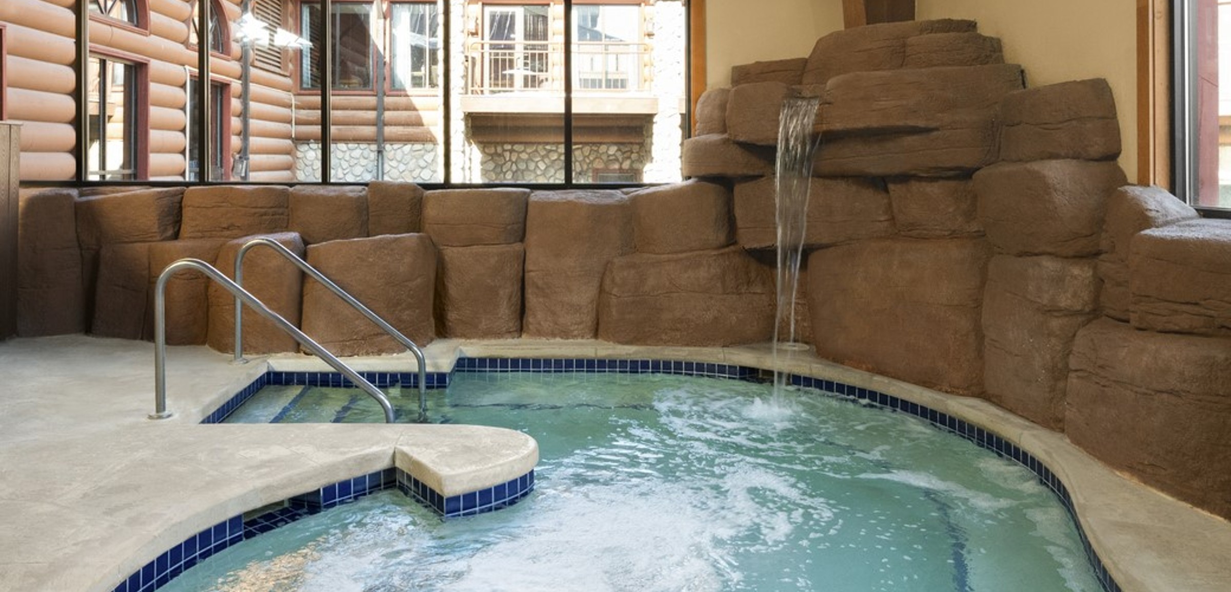 A family of four relaxes in the indoor pool