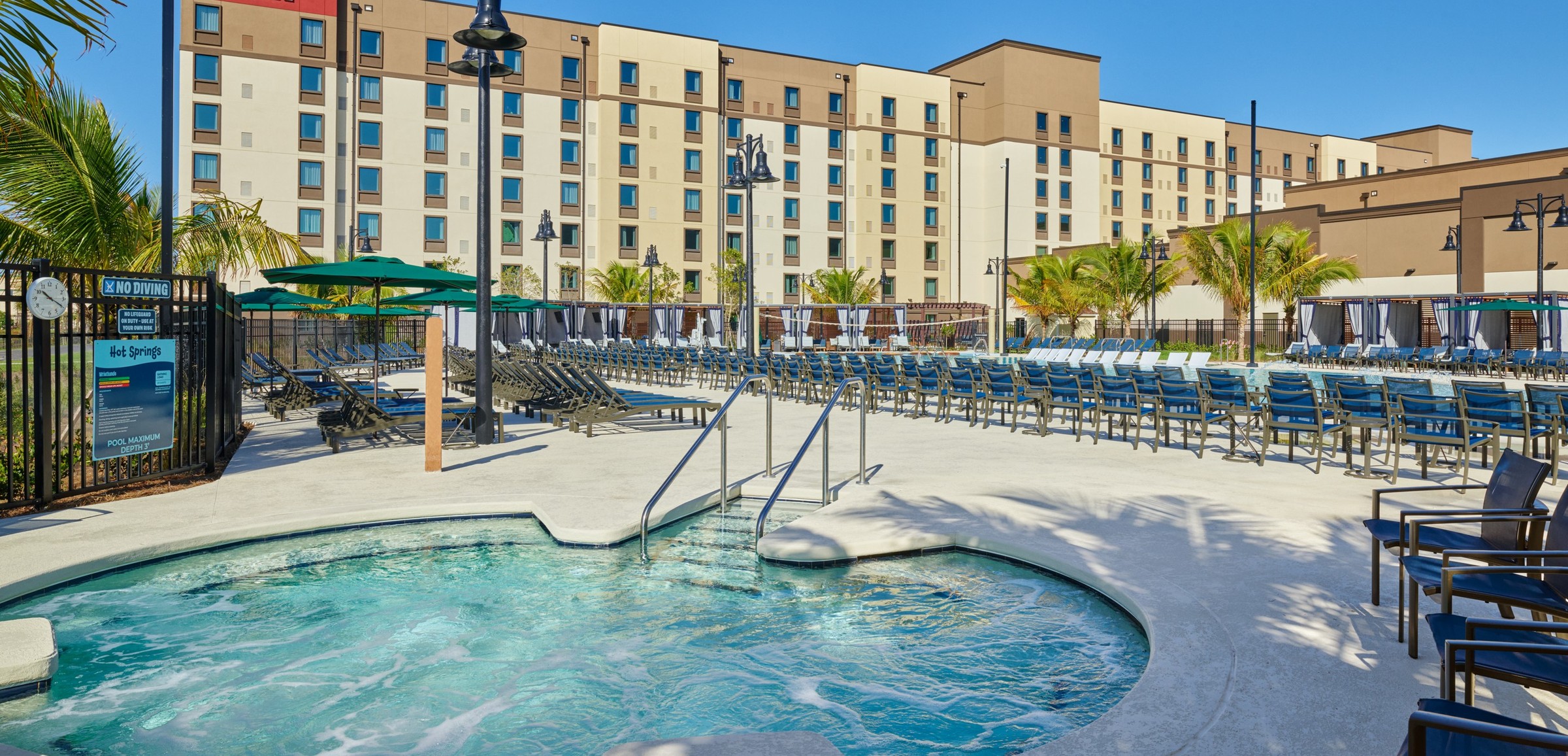 view of an outdoor hut tubs and palm trees